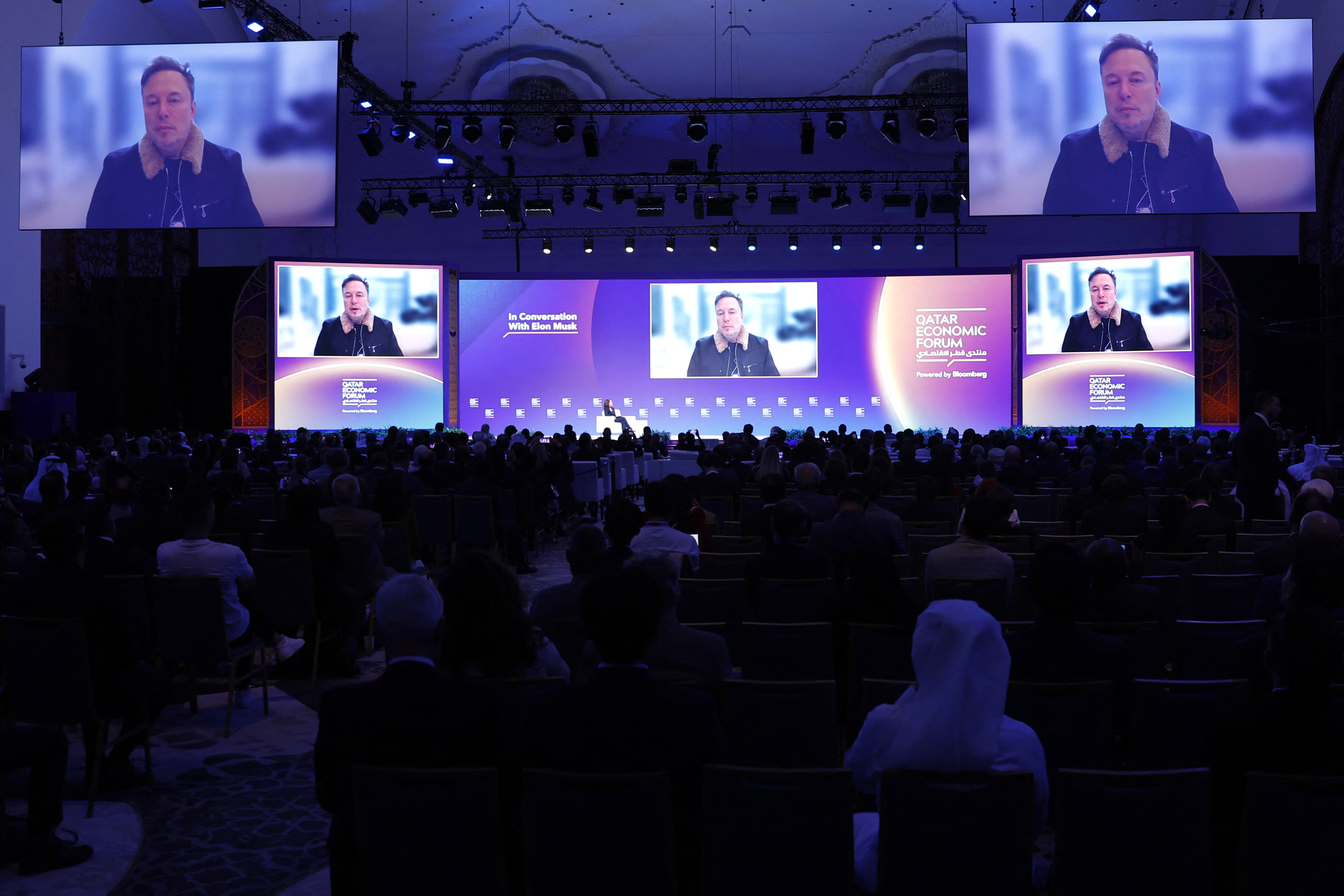 Elon Musk speaks at the Qatar Economic Forum in Doha on May 20, 2025. (Photo by Karim JAAFAR / AFP