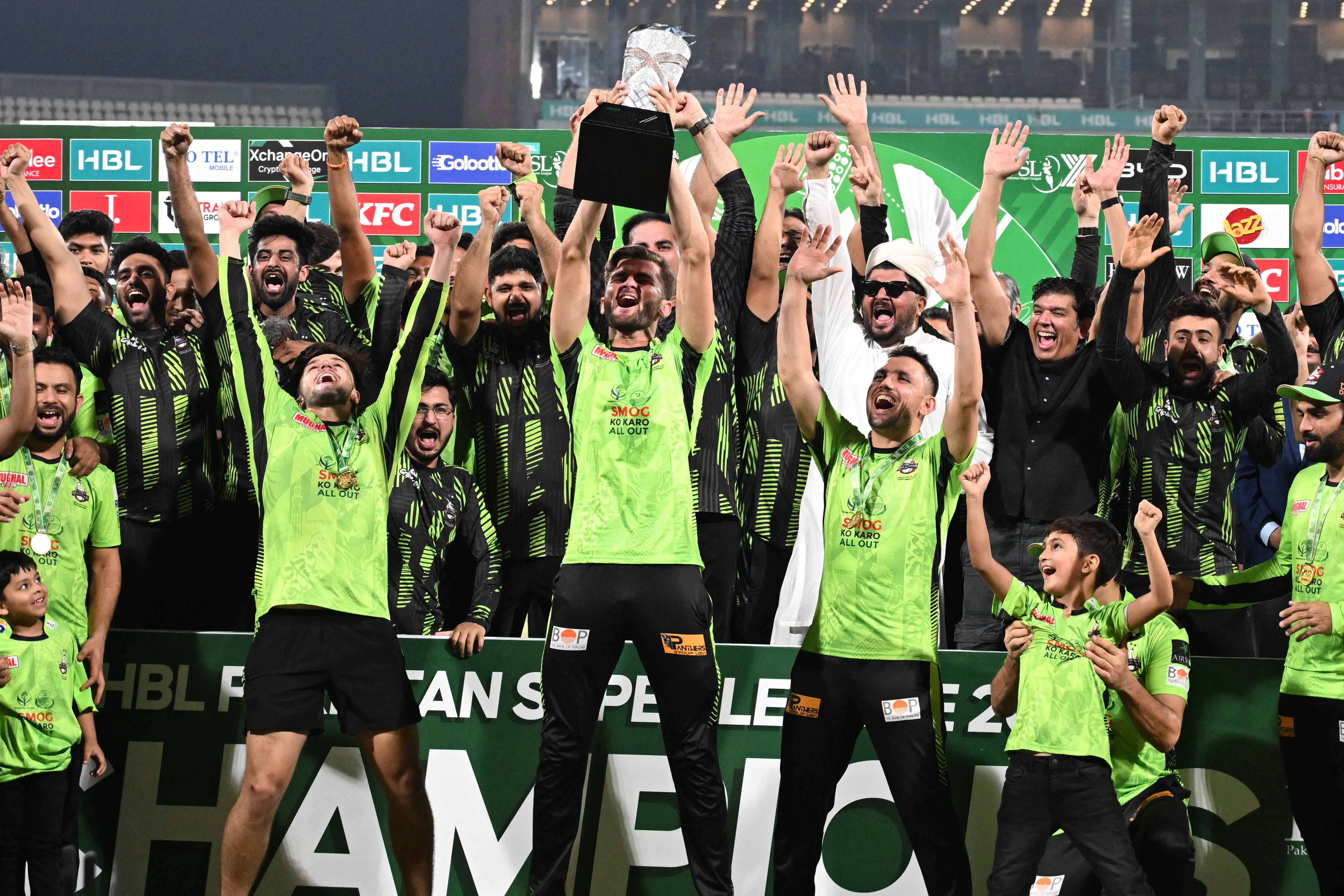 Lahore Qalanders' captain Shaheen Shah Afridi (C) celebrates with the trophy with players during the victory ceremony at the end of the Pakistan Super League (PSL) Twenty20 final cricket match between Lahore Qalandars and Quetta Gladiators at the Qaddafi Cricket Stadium in Lahore on May 25, 2025. (Photo by Aamir QURESHI / AFP)