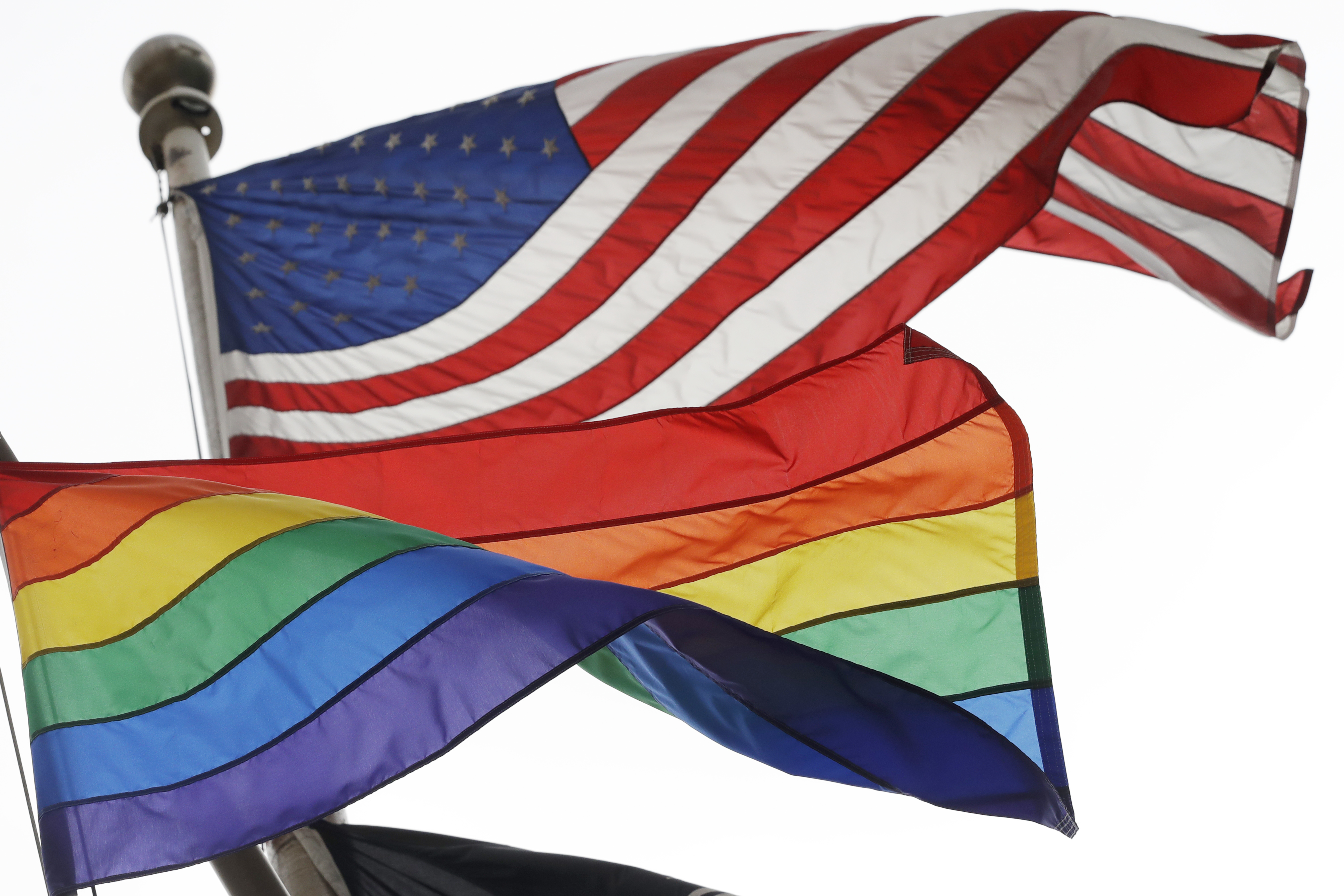 The Rainbow Flag, an international symbol of LGBTQ+ liberation and pride, flies beneath the American flag at the Stonewall National Monument on October 11, 2017 in New York.