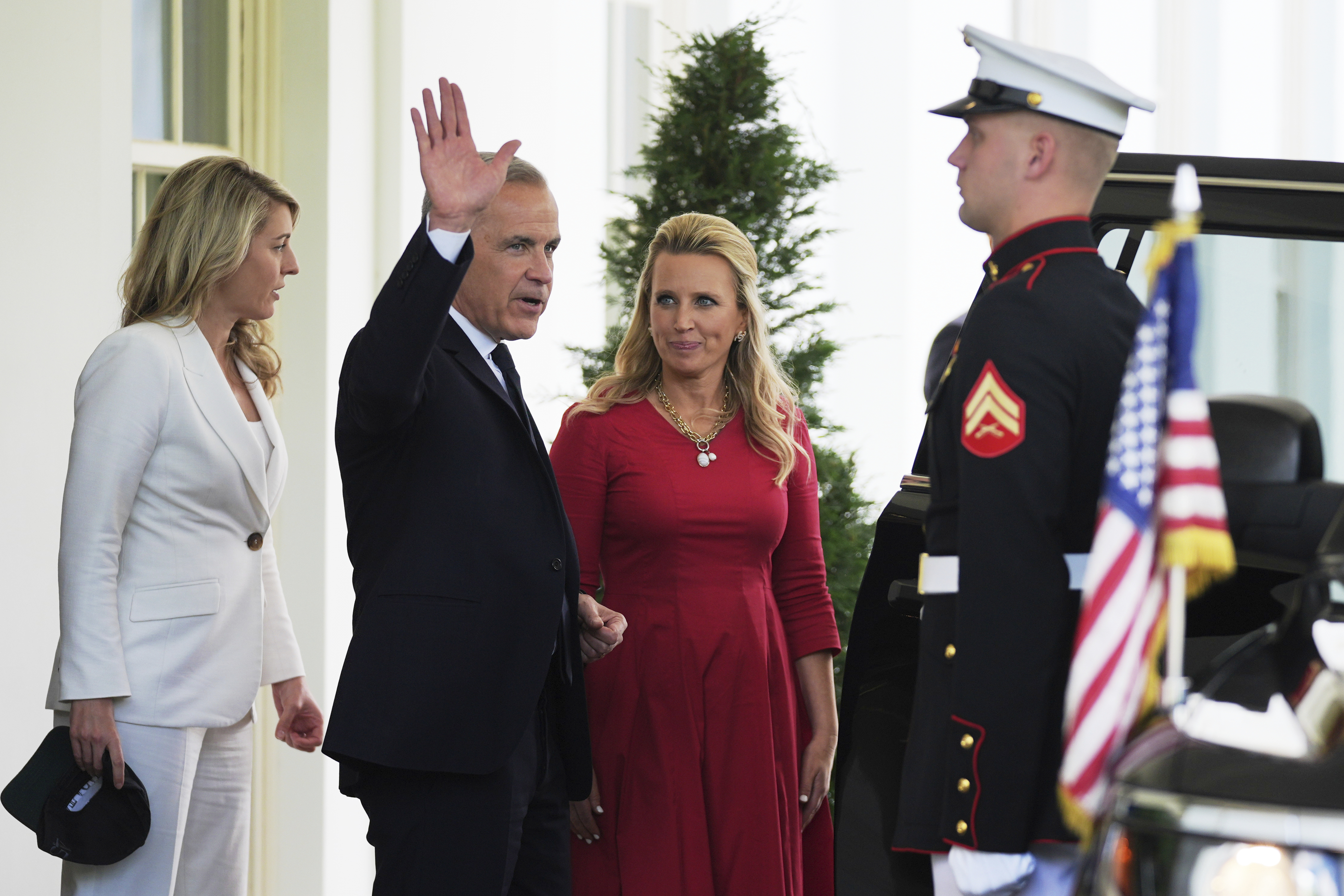 Mark Carney waves goodbye as he exits the White House