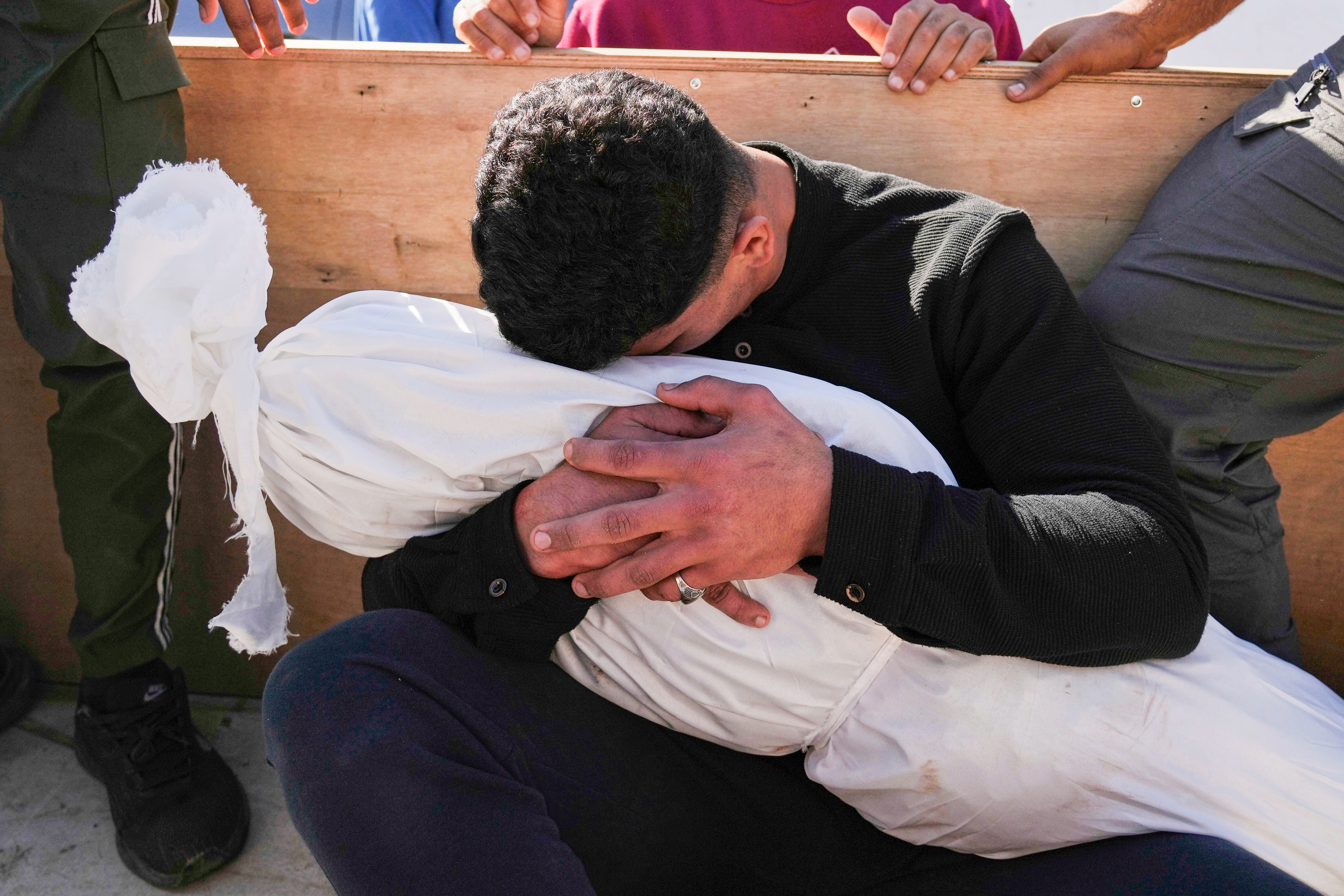 A Palestinian man embraces the body of his 5-year-old son