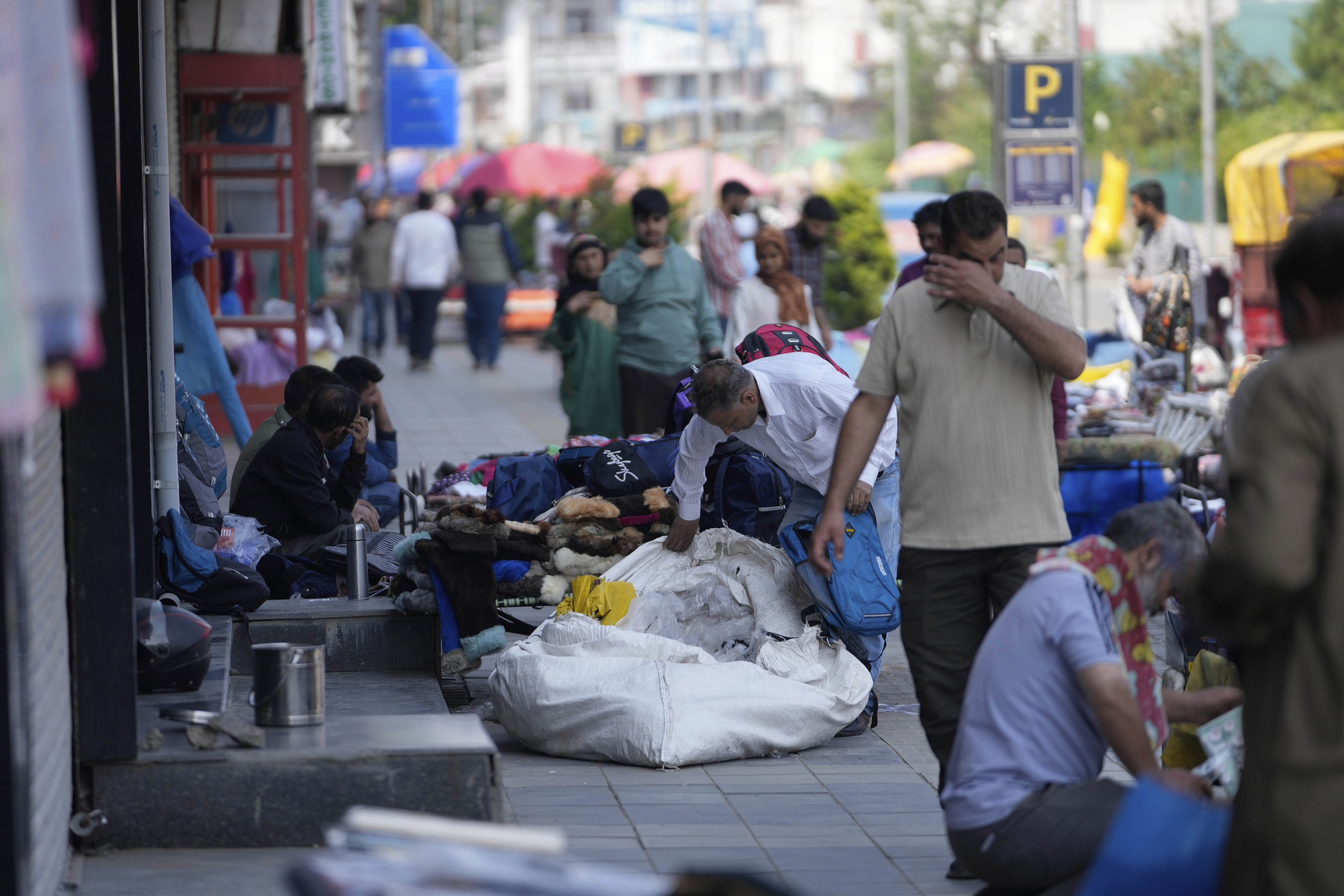 People walk at a open market, day after the ceasefire between Indian and Pakistan in Srinagar, in Indian controlled Kashmir, Sunday, May 11, 2025.(AP Photo/Mukhtar Khan)