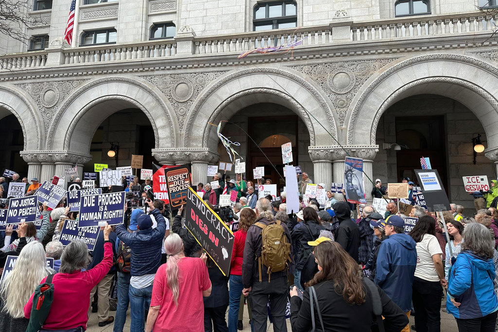 A crowd protests outside of a courthouse