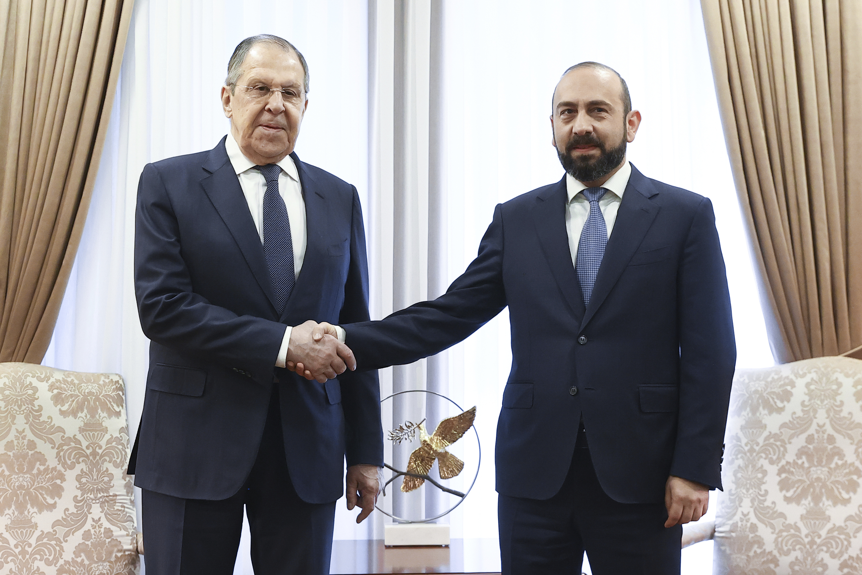 Russian Foreign Minister Sergey Lavrov and Armenian Foreign Minister Ararat Mirzoyan shake hands during their meeting in Yerevan, Armenia