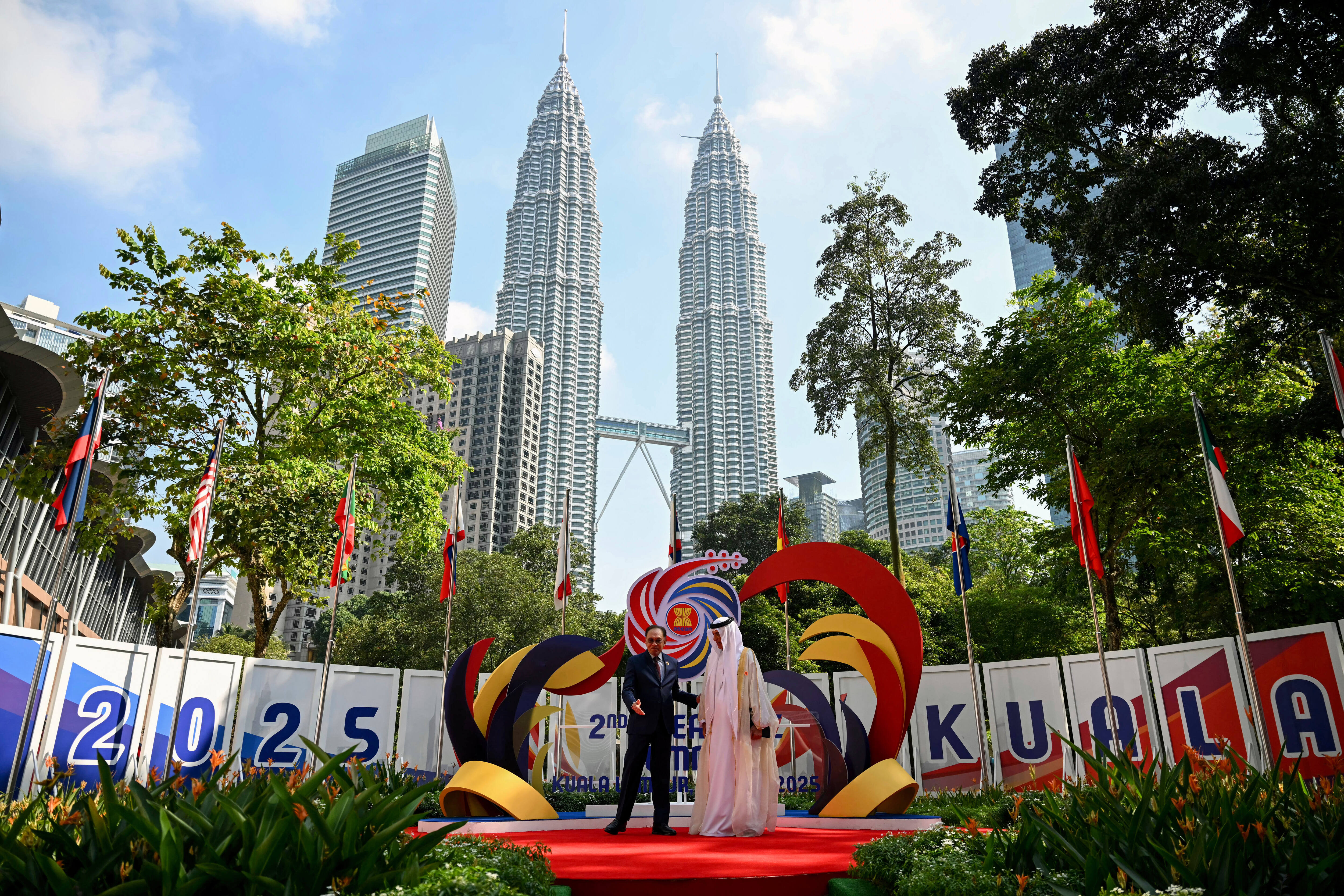 Malaysia's Prime Minister Anwar Ibrahim, left, greets ruler of the UAE emirate of Ras al-Khaimah Sheikh Saud bin Saqr al-Qasimi.