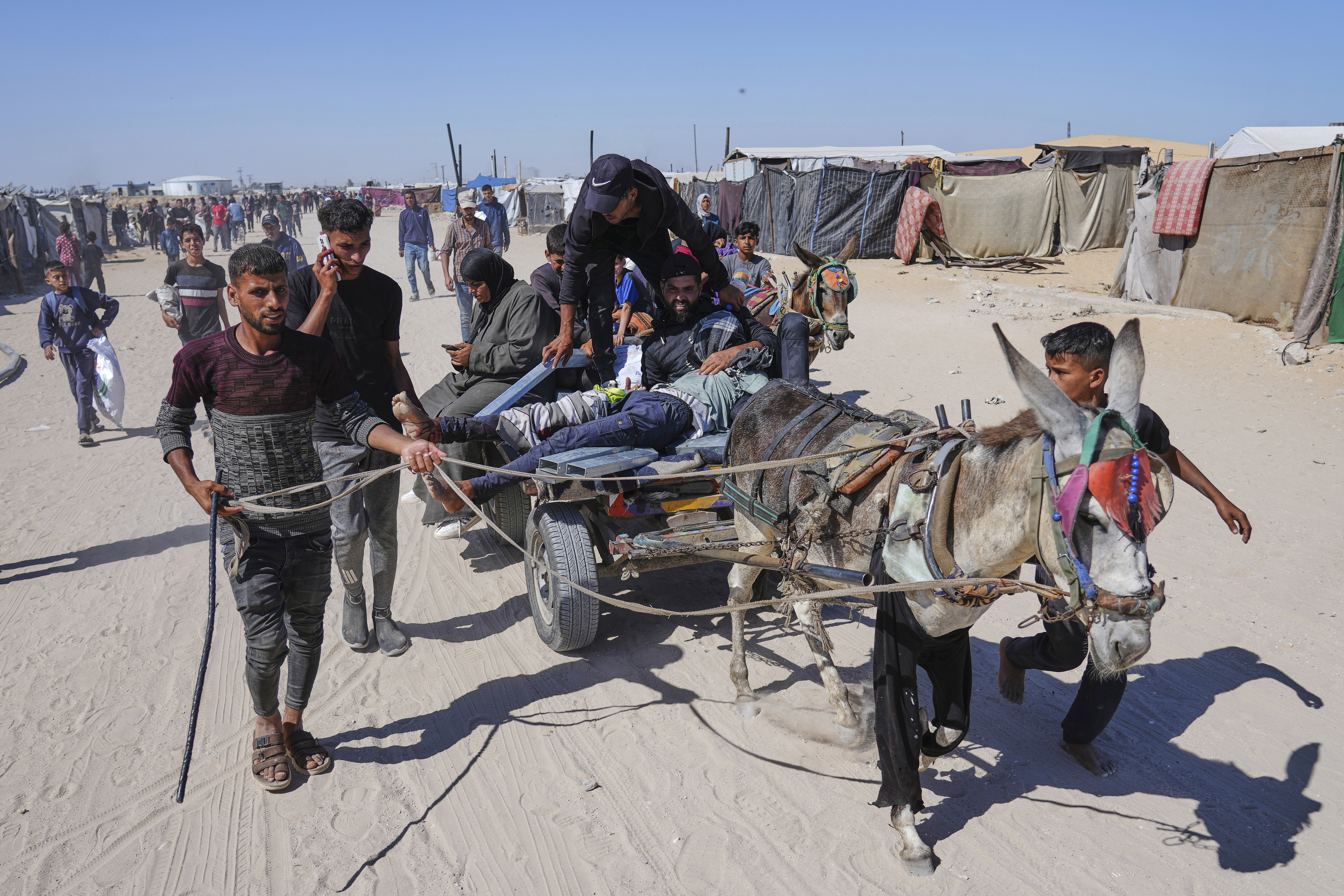 Palestinians carry an injured man after he was shot at an aid distribution center run by the Gaza Humanitarian Foundation a US-backed organization approved by Israel in Khan Younis, southern Gaza Strip, on Thursday, May 29, 2025. [Abdel Kareem Hana/AP]