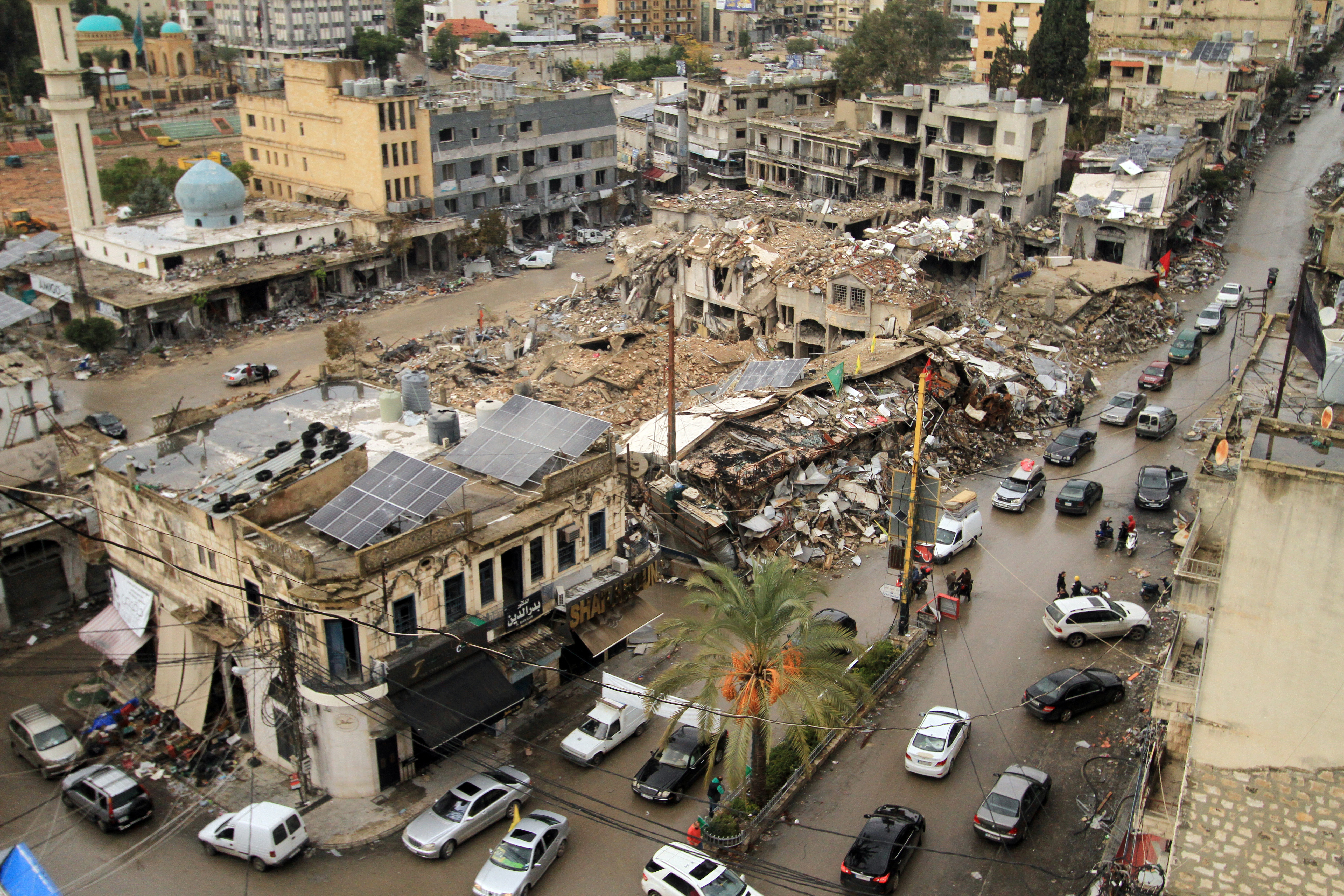 A view of the damaged square where the market is held, debris covers everything and entire buildings have collapsed