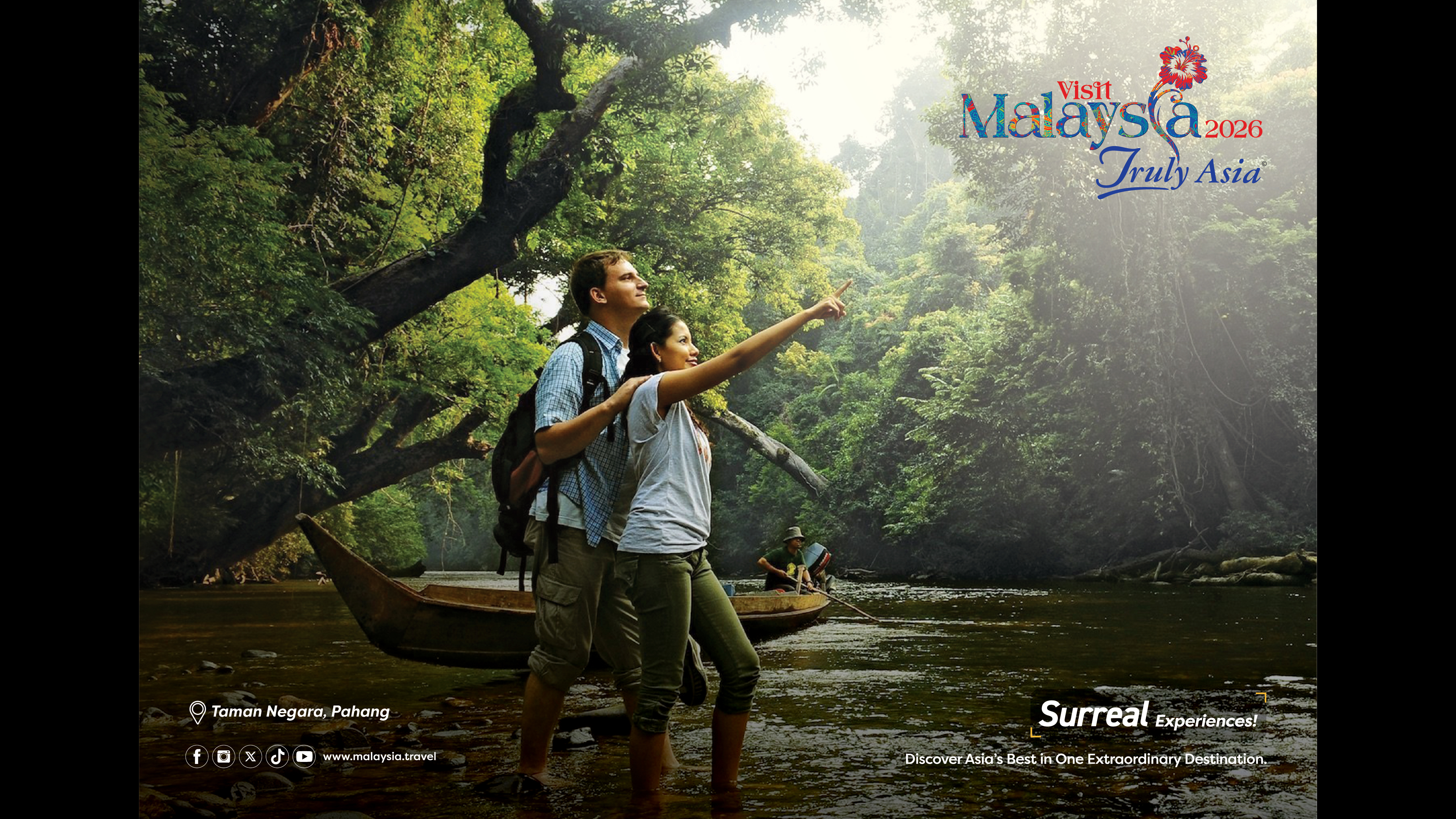 Two people stand in a river surrounded by jungle