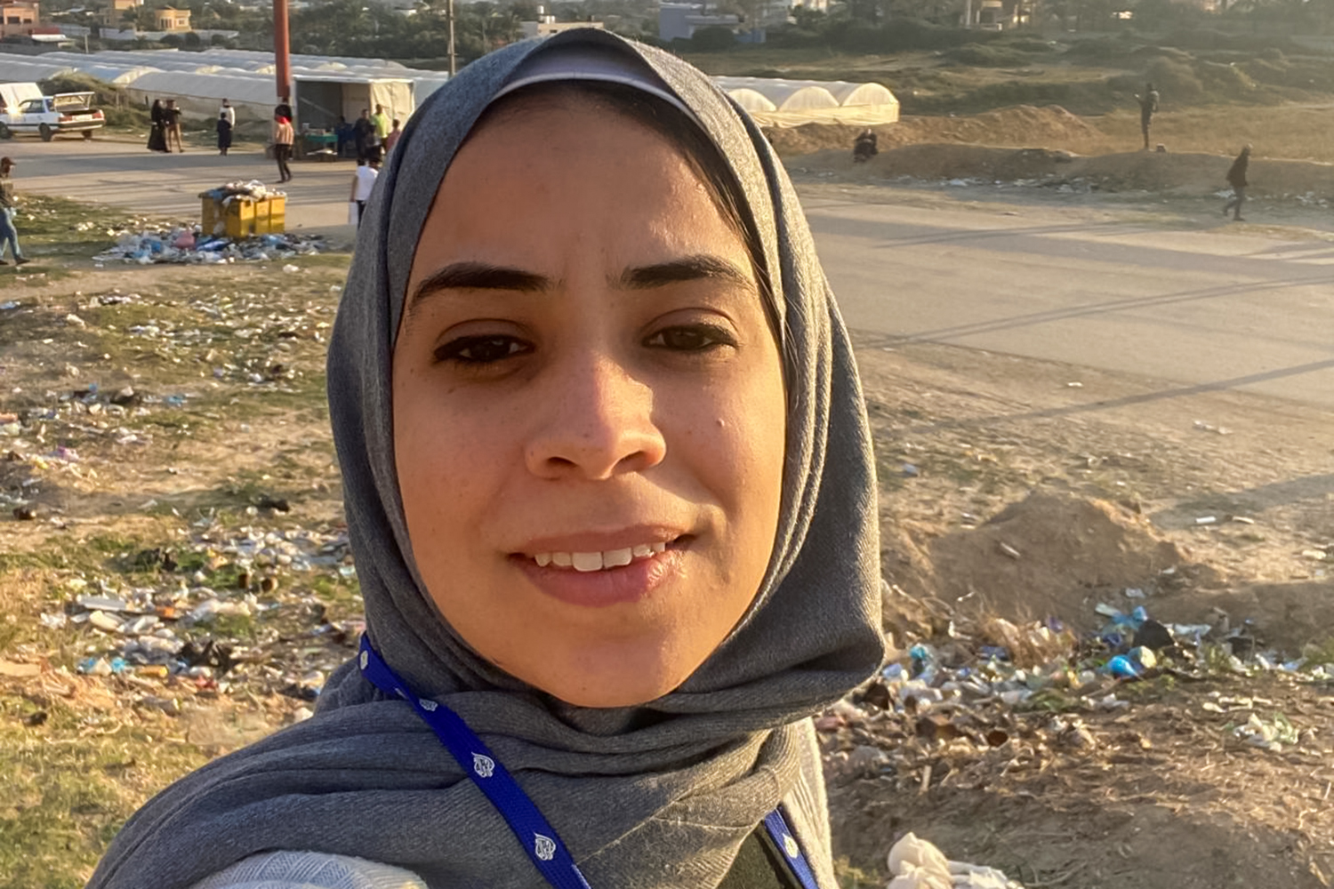 Maram Humaid with rubble behind her