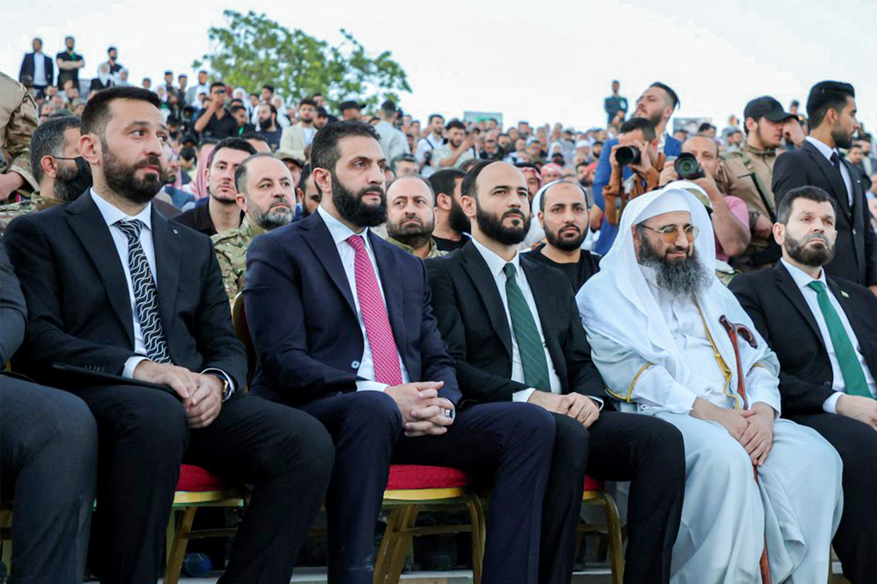 This handout picture released by the official Syrian Arab News Agency (SANA) shows Syria's interim president Ahmed al-Sharaa (2nd-L) attending an event at the Aleppo Citadel on May 27, 2025 to mark six months since then-rebel forces captured the northern city of Aleppo from ousted president Bashar al-Assad's forces, paving the way to seize other major cities.