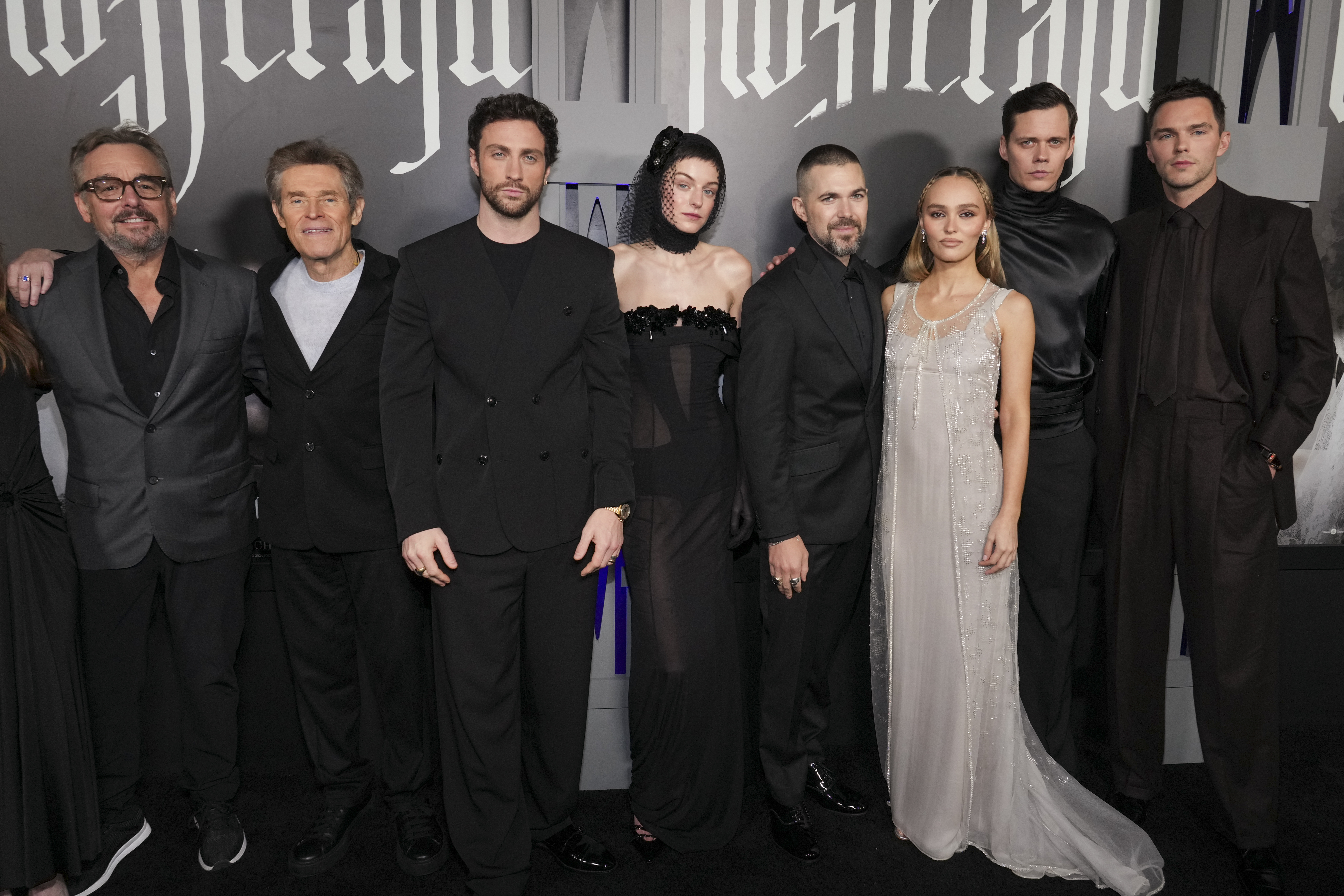Chris Columbus, from left, Willem Dafoe, Aaron Taylor-Johnson, Emma Corrin, Robert Eggers, Lily-Rose Depp, Bill Scarsgard, and Nicholas Hoult arrive at the premiere of "Nosferatu" on Thursday, Dec. 12, 2024, at TCL Chinese Theatre in Los Angeles. (Photo by Jordan Strauss/Invision/AP)