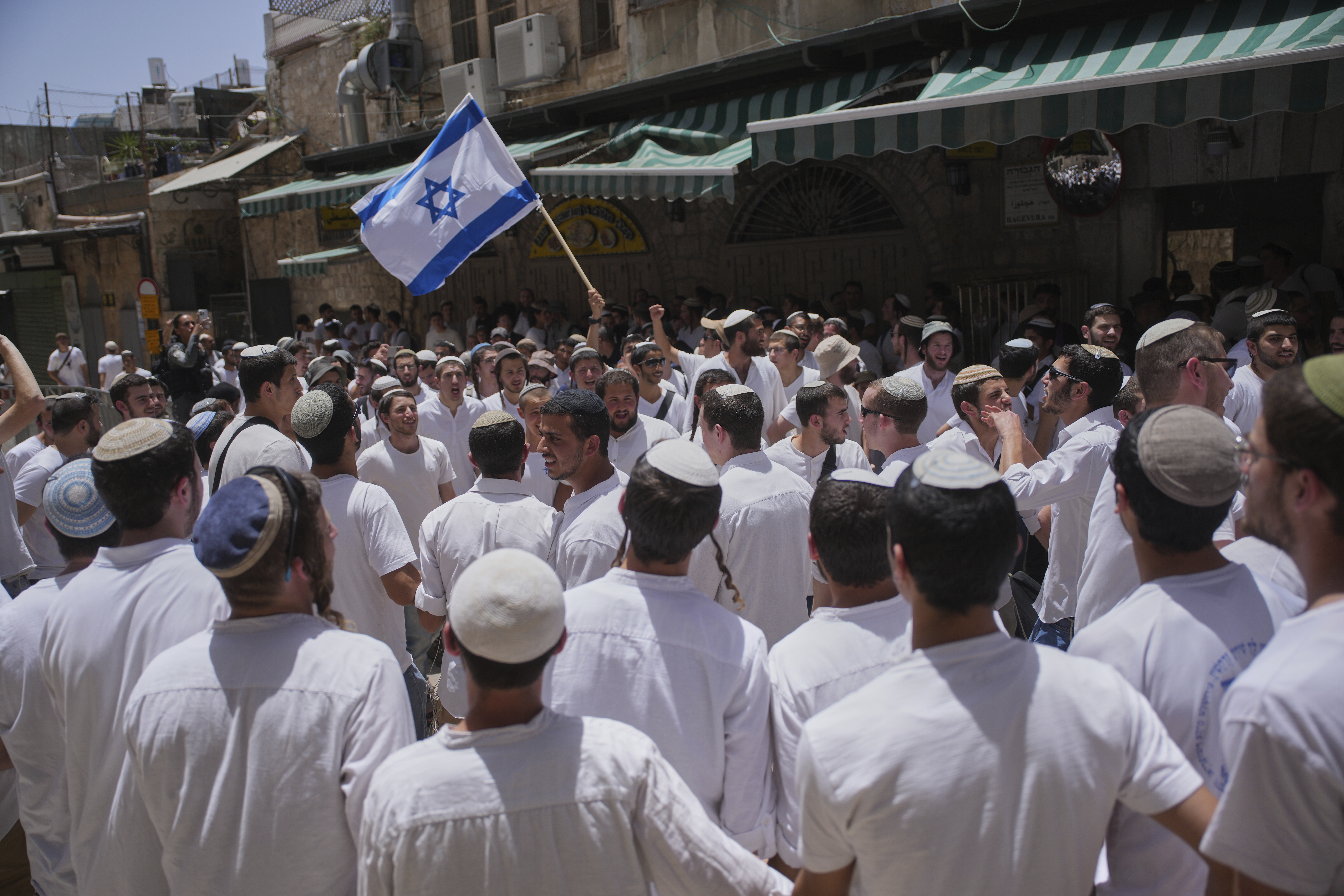Israelis wave national flags during a march marking Jerusalem Day, an Israeli holiday celebrating the capture of east Jerusalem in the 1967 Mideast war, in Jerusalem's Old City, Monday, May 26, 2025. (AP Photo/Ohad Zwigenberg)
