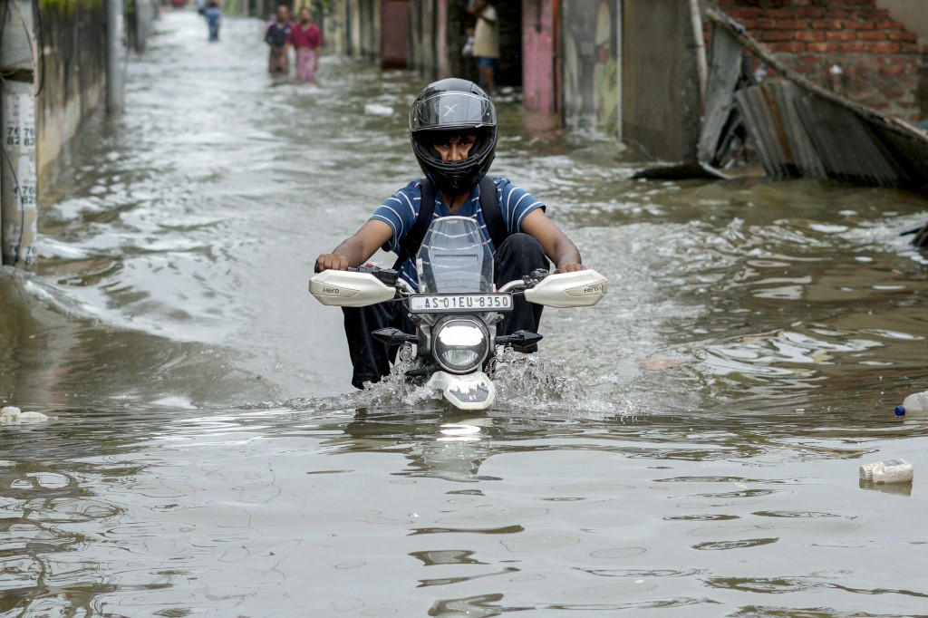 A motorcyclist wades through a flooded street after heavy rains in Guwahati, in India's Assam state on May 31, 2025. [File: Biju Boro/AFP]