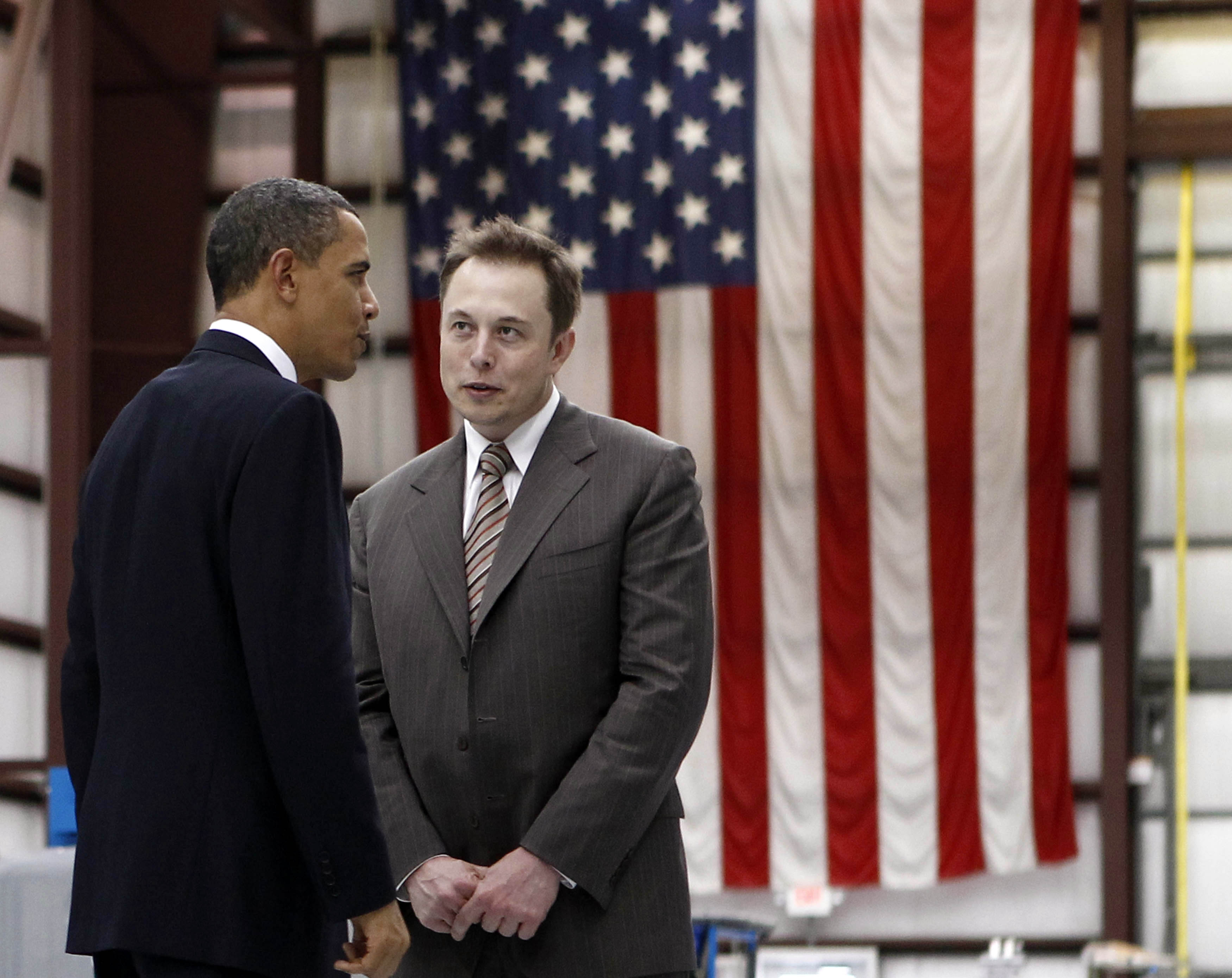 U.S. President Barack Obama (L) speaks to Head of SpaceX Elon Musk on a tour of Cape Canaveral Air Force Station in Cape Canaveral, Florida, April 15, 2010. REUTERS/Jim Young (UNITED STATES - Tags: POLITICS)