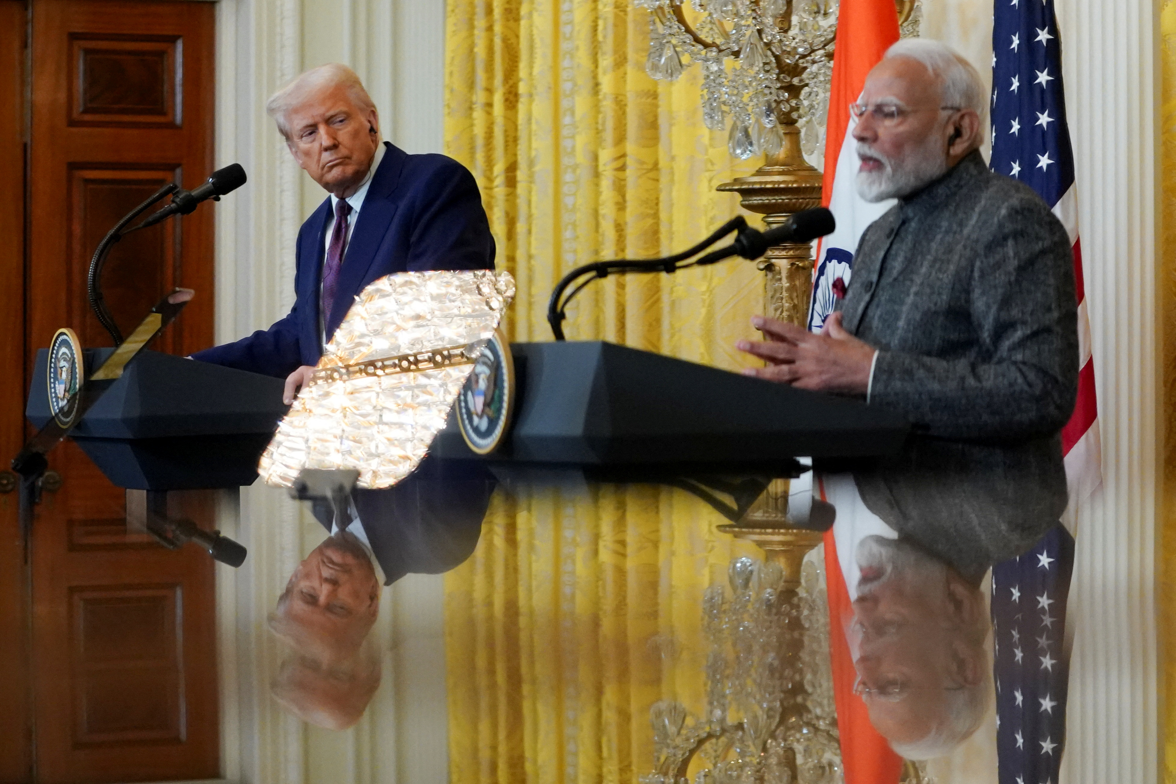 U.S. President Donald Trump and Indian Prime Minister Narendra Modi are pictured in a mirror as they attend a joint press conference at the White House in Washington, D.C., U.S., February 13, 2025. REUTERS/Nathan Howard