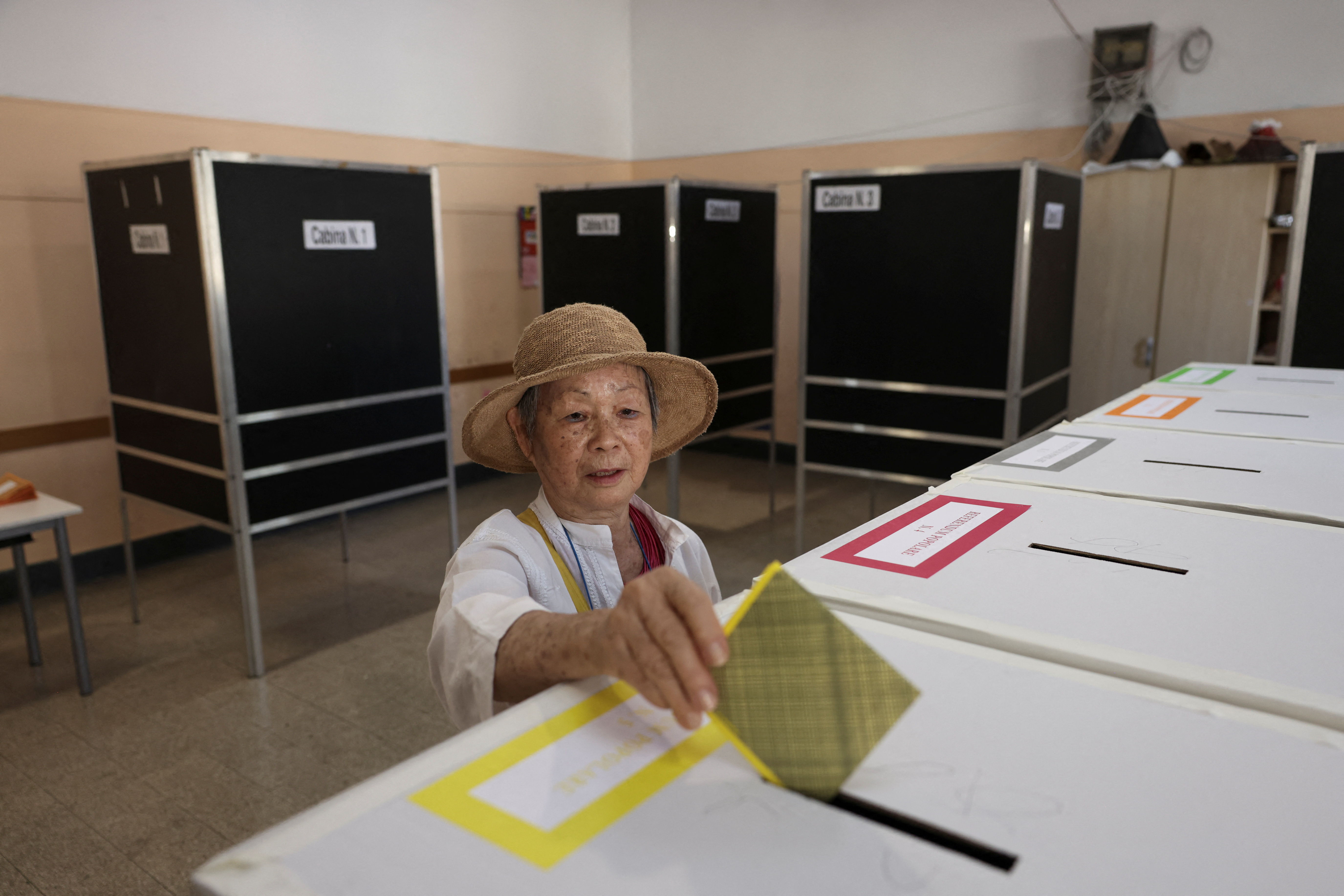 A person votes during a referendum on employment and Italian citizenship at a polling station in Rome