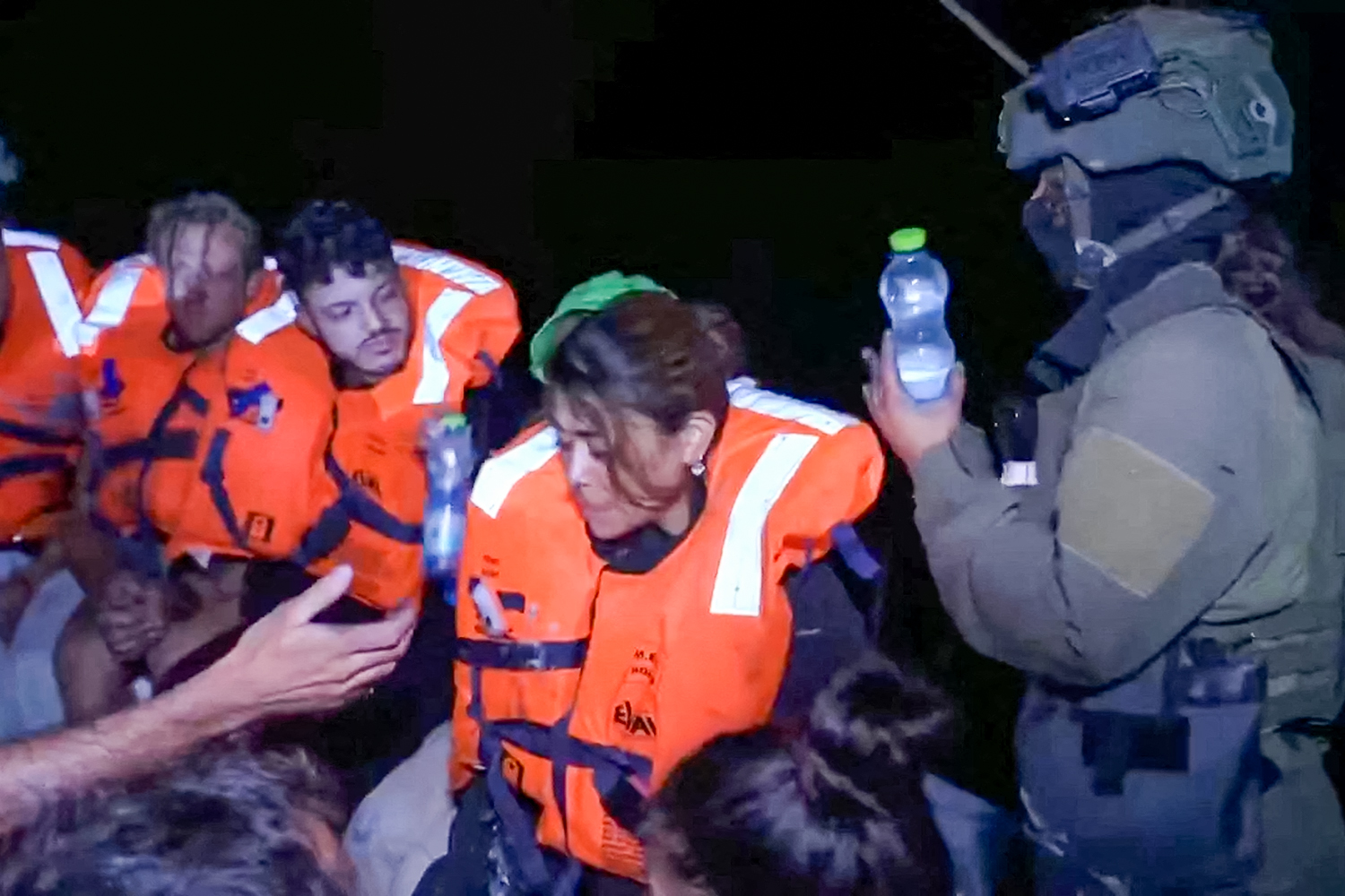 An Israeli solider passes water to those on board the Gaza-bound British-flagged yacht Madleen