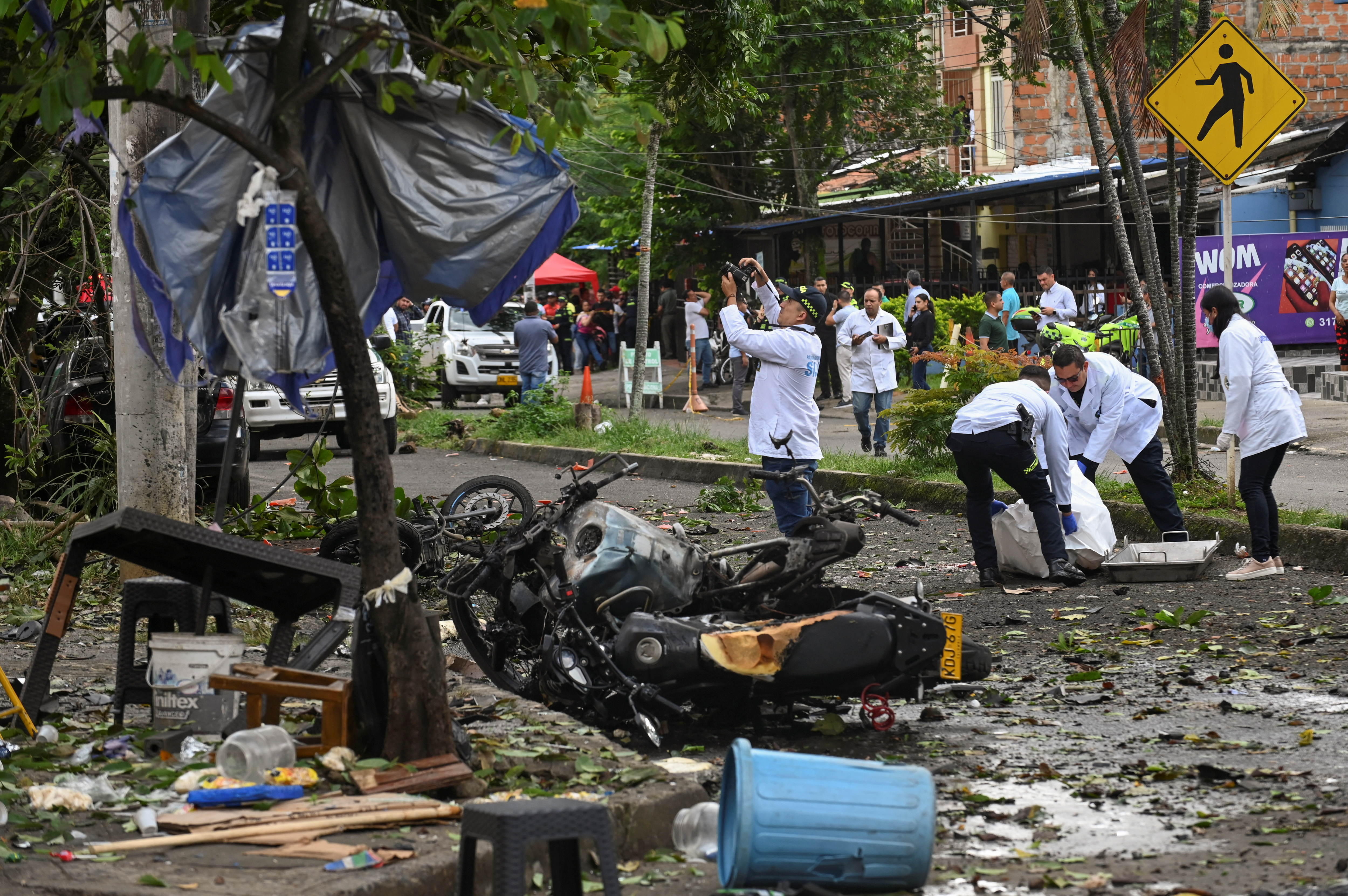 Forensic technicians examine the site of a motorcycle explosion in front of a police station at Melendez neighborhood, in Cali, Colombia, June 10, 2025. REUTERS/Stringer