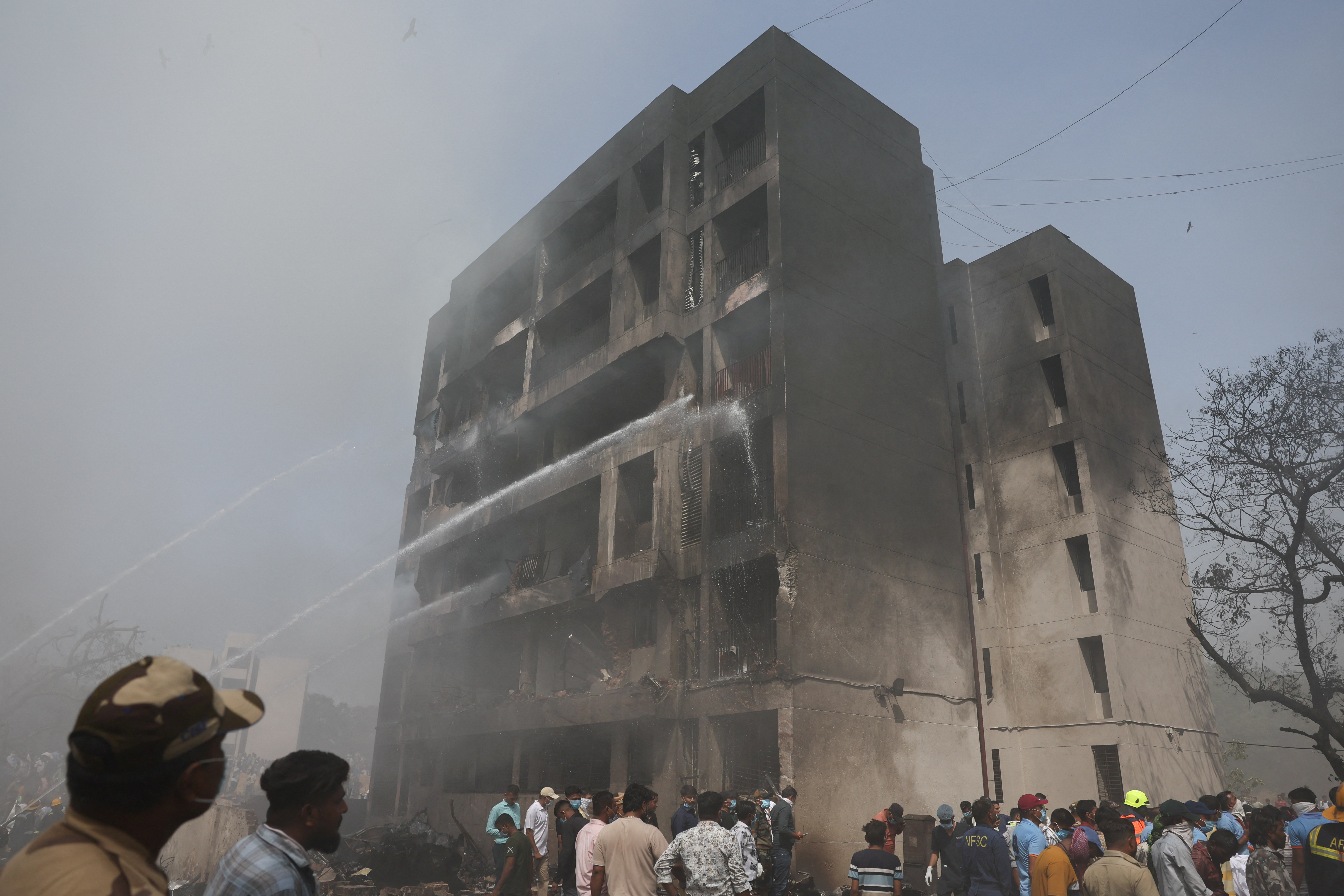 Firefighters work at the site of the Air India Flight 171 crash in Ahmedabad, India