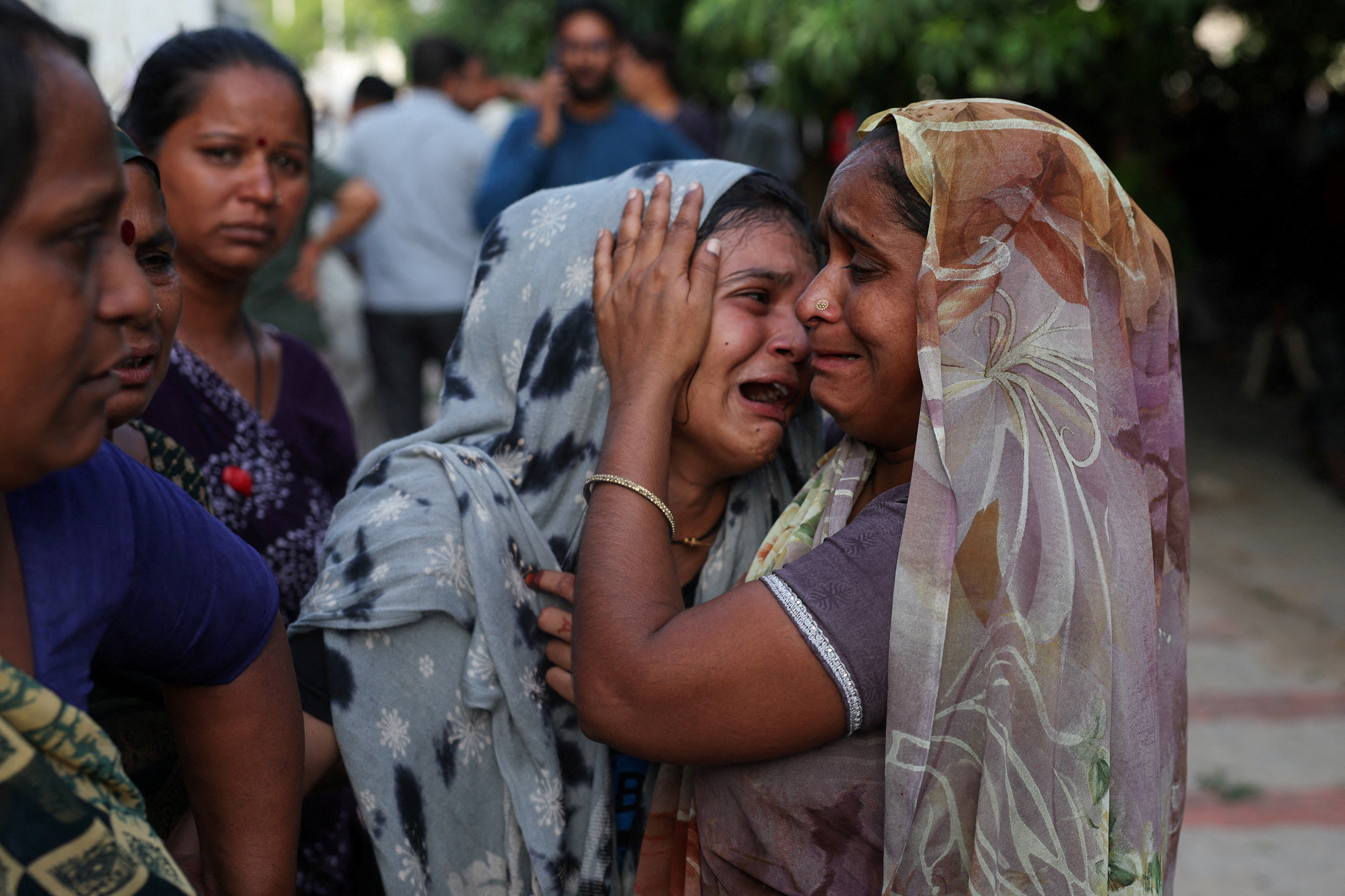 Dabu Patni cries upon hearing the news of her brother Akash Patni, who died when the Air India Boeing 787 Dreamliner plane crashed in Ahmedabad