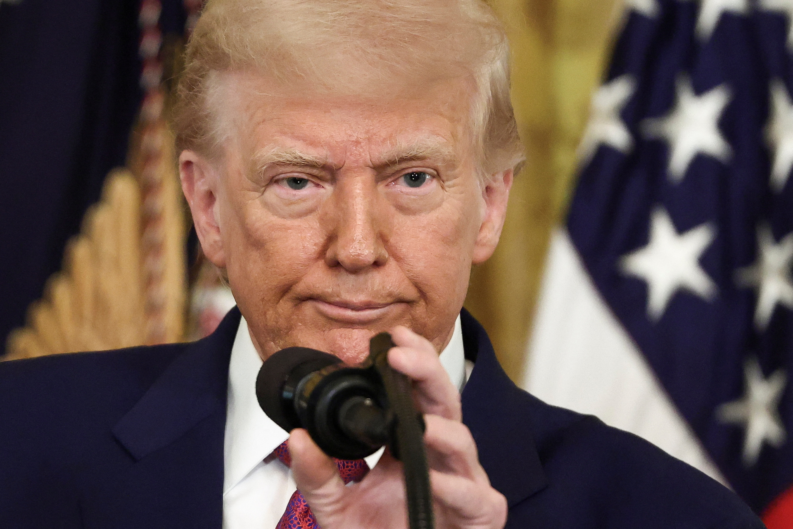 Trump holding a microphone