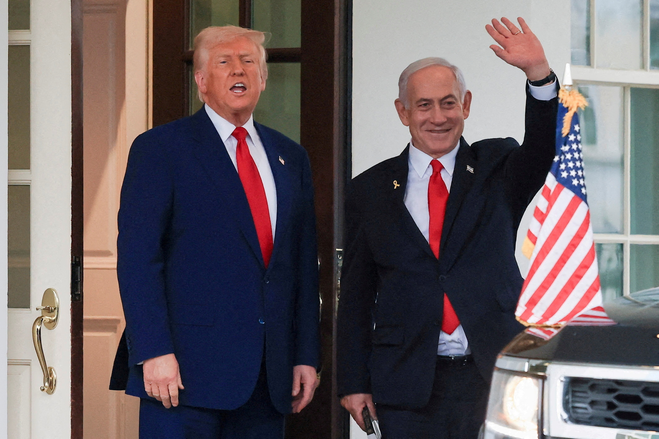 US President Donald Trump speaks as Israeli Prime Minister Benjamin Netanyahu waves at the White House, in Washington, DC.