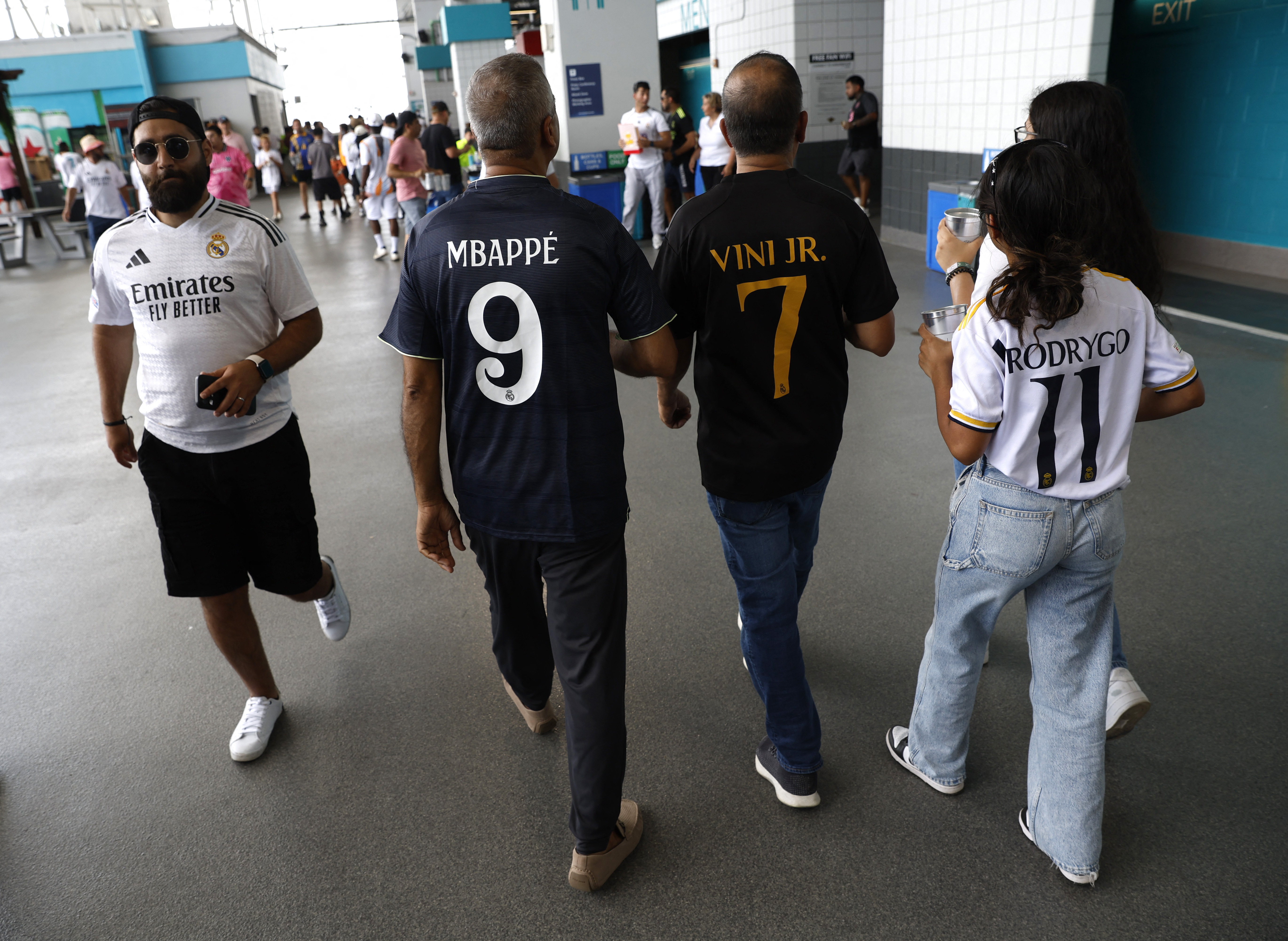 Soccer Football - FIFA Club World Cup - Group H - Real Madrid v Al Hilal - Hard Rock Stadium, Miami Gardens, Florida, U.S. - June 18, 2025 Fans wearing replica shirts of Real Madrid's Kylian Mbappe, Vinicius Junior and Rodrygo before the match REUTERS/Marco Bello