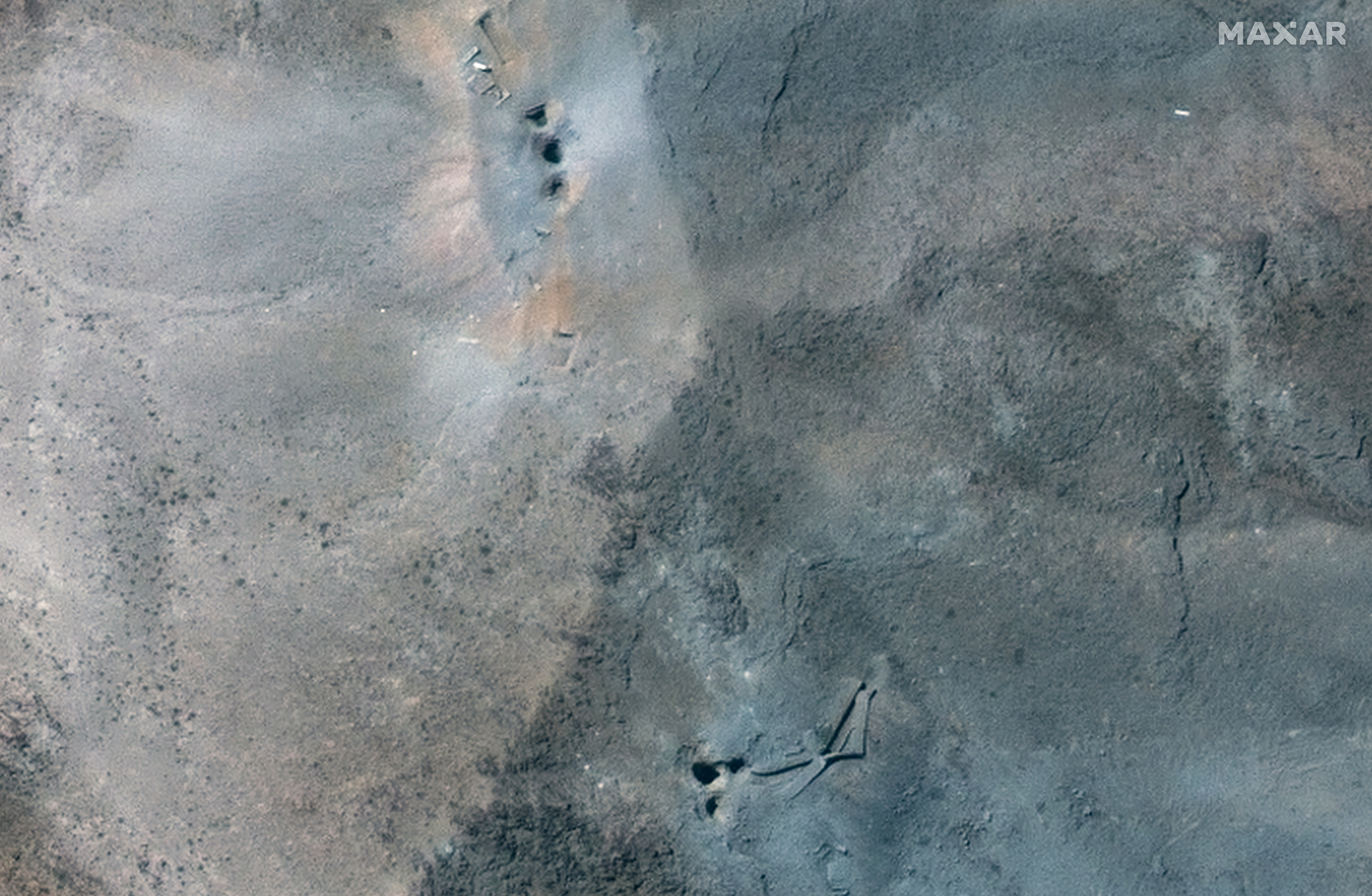 A closer satellite view shows holes and craters on a ridge at Fordow underground complex, after the U.S. struck the underground nuclear facility, near Qom, Iran June 22, 2025.
