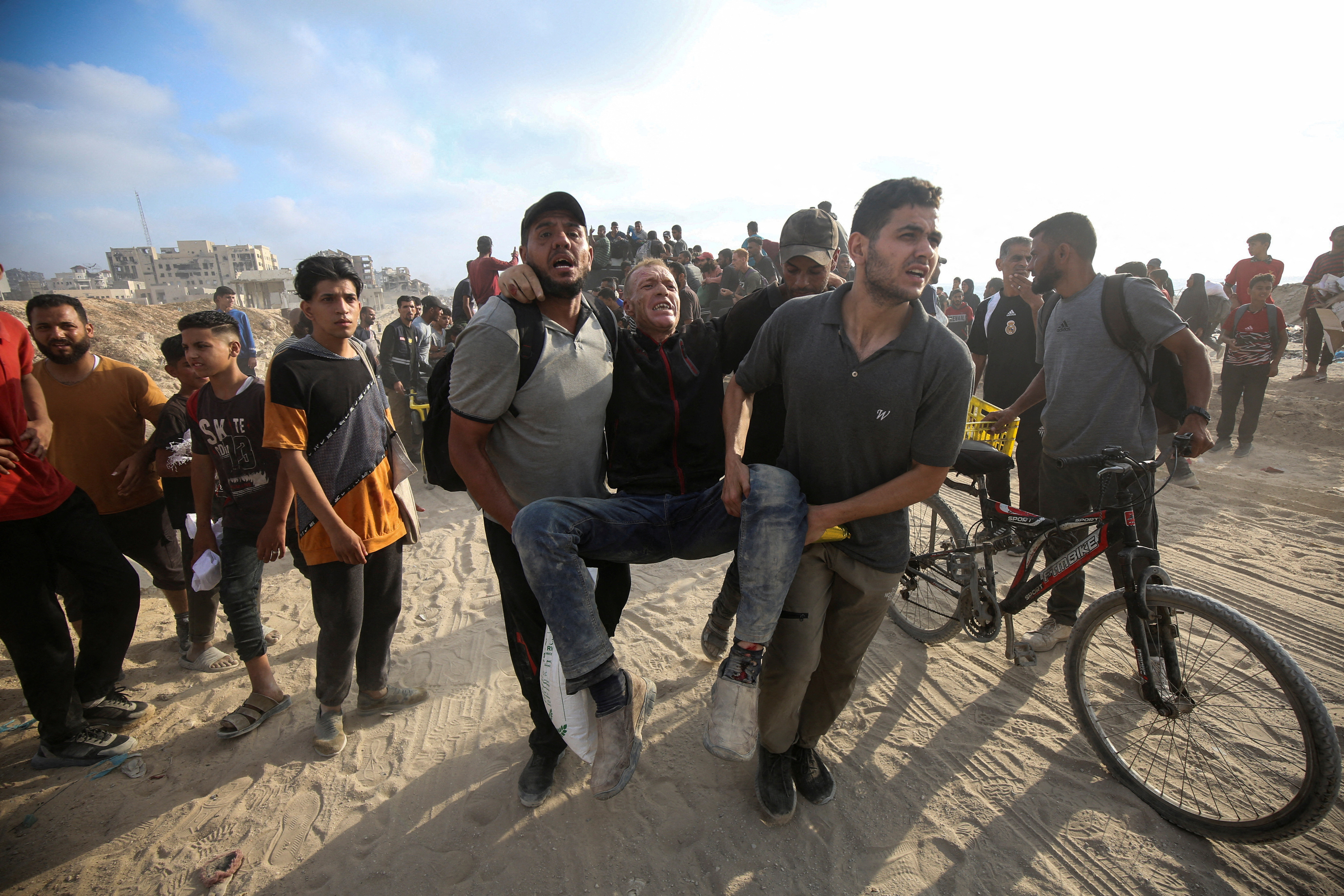 Palestinians carry a wounded man in Beit Lahia, in northern Gaza