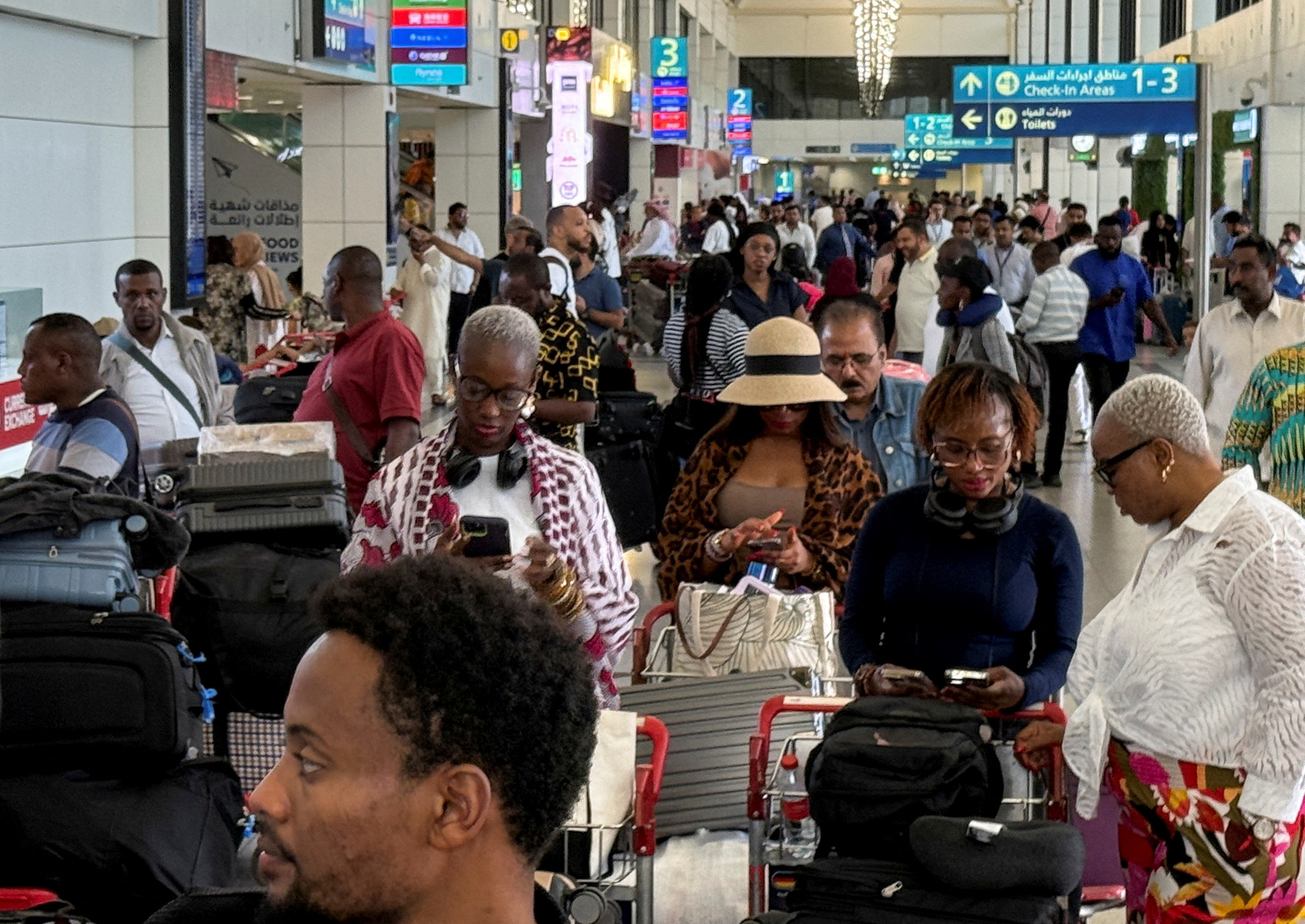 Passengers queue at Dubai International Airport, following Iran Monday's attack on a U.S. military base, in Dubai, United Arab Emirates, June 24, 2025.