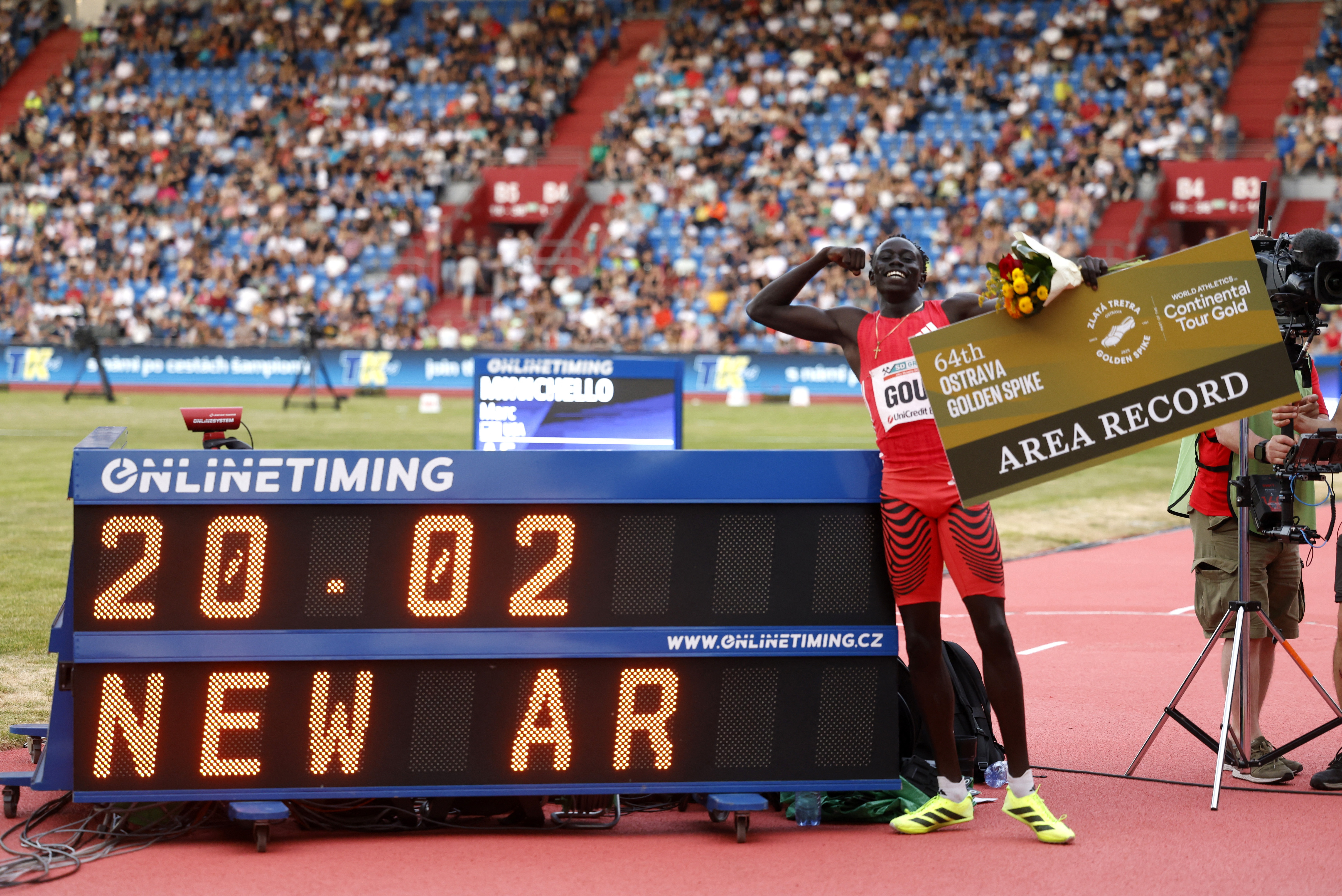 Athletics - Ostrava Golden Spike Meeting - Mestsky Stadion, Ostrava, Czech Republic - June 24, 2025 Australia's Gout Gout poses next to a scoreboard as he celebrates winning the men's 200m by setting a new area record REUTERS/David W Cerny