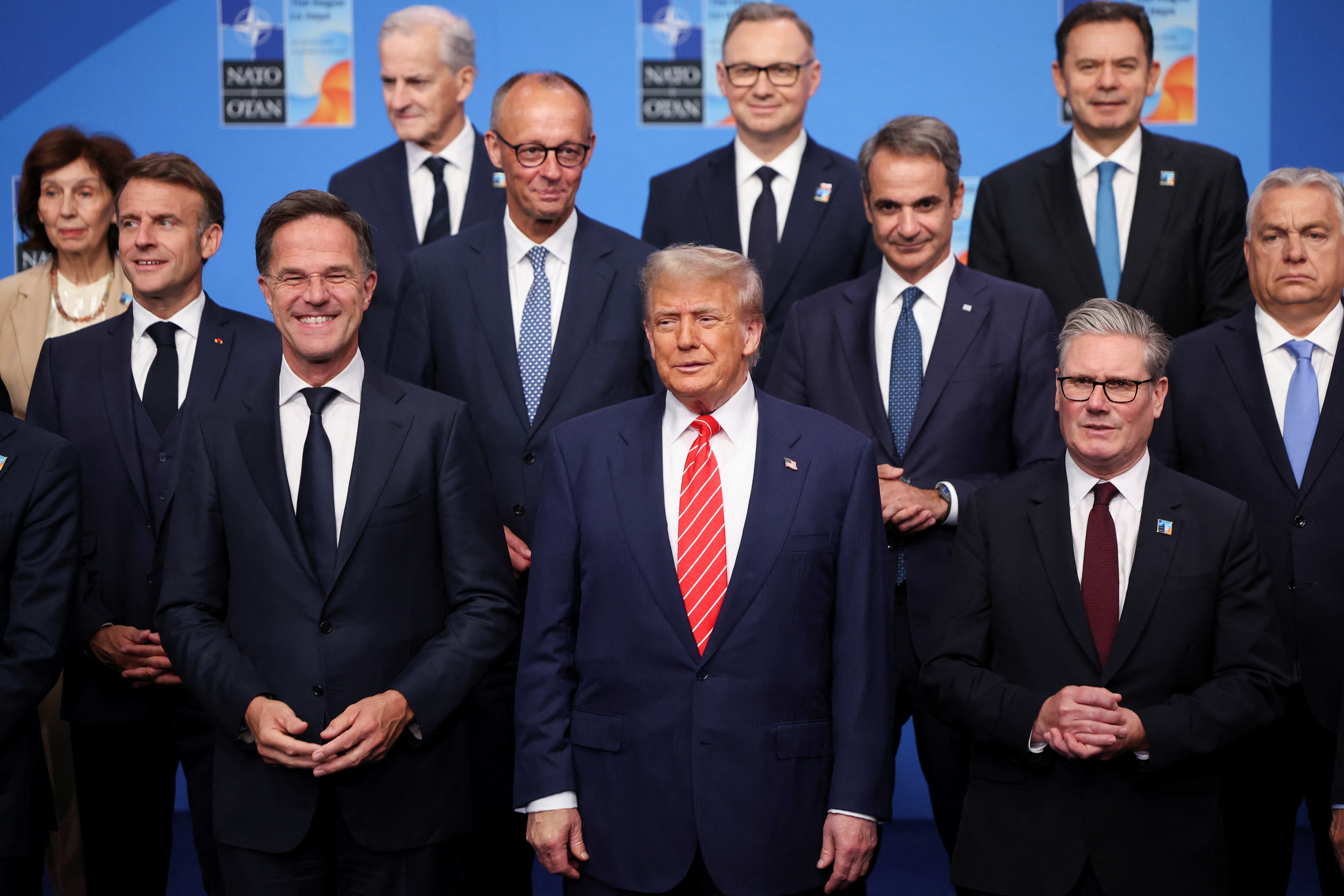 NATO Secretary General Mark Rutte, U.S. President Donald Trump, Britain's Prime Minister Keir Starmer, France's President Emmanuel Macron, German Chancellor Friedrich Merz, Greek Prime Minister Kyriakos Mitsotakis and Hungarian Prime Minister Viktor Orban pose for a family photo with NATO leaders during a NATO leaders summit in The Hague, Netherlands