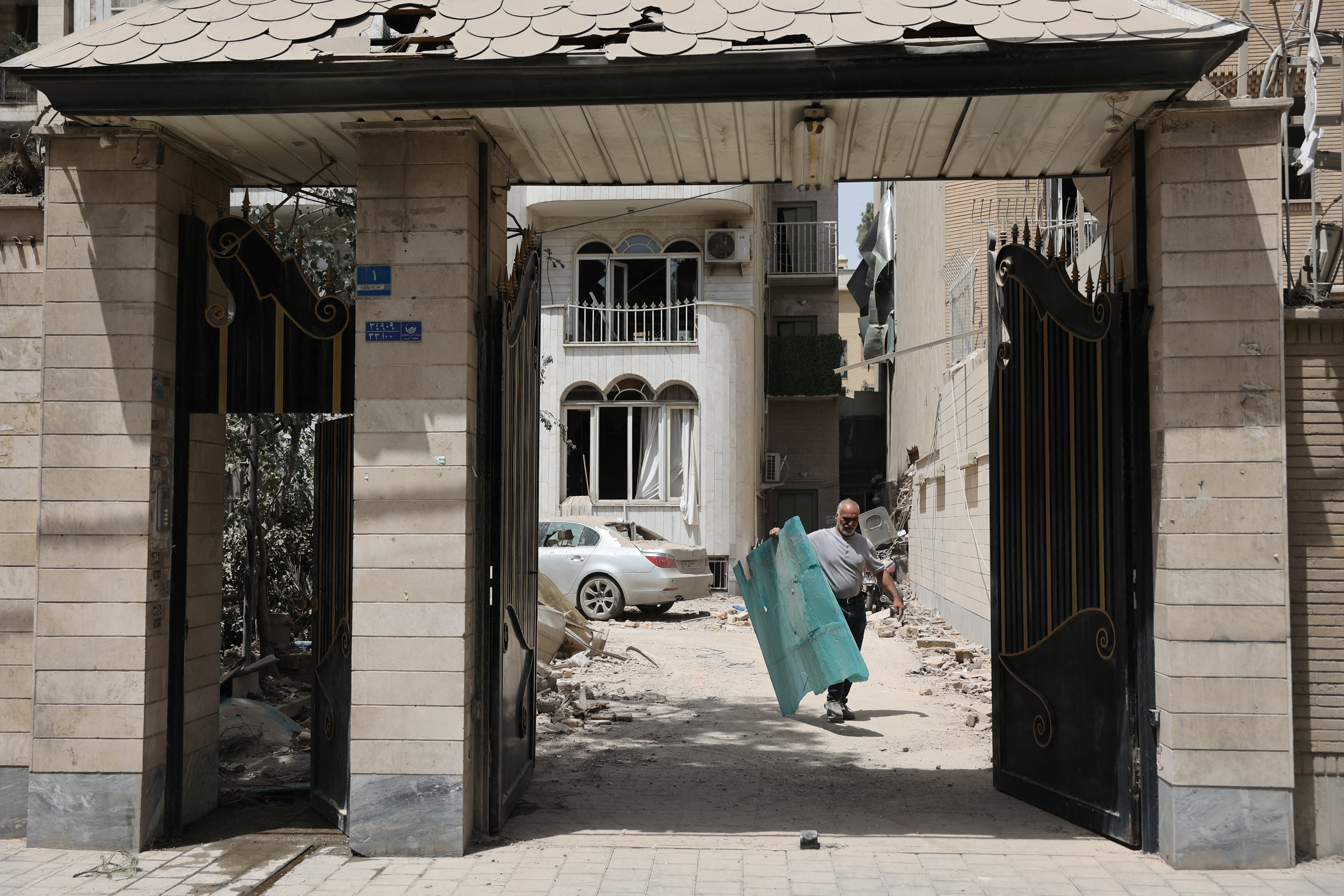 A man works in a house following an Israeli strike on a building on Monday, after the ceasefire between Israel and Iran, in Tehran, Iran.