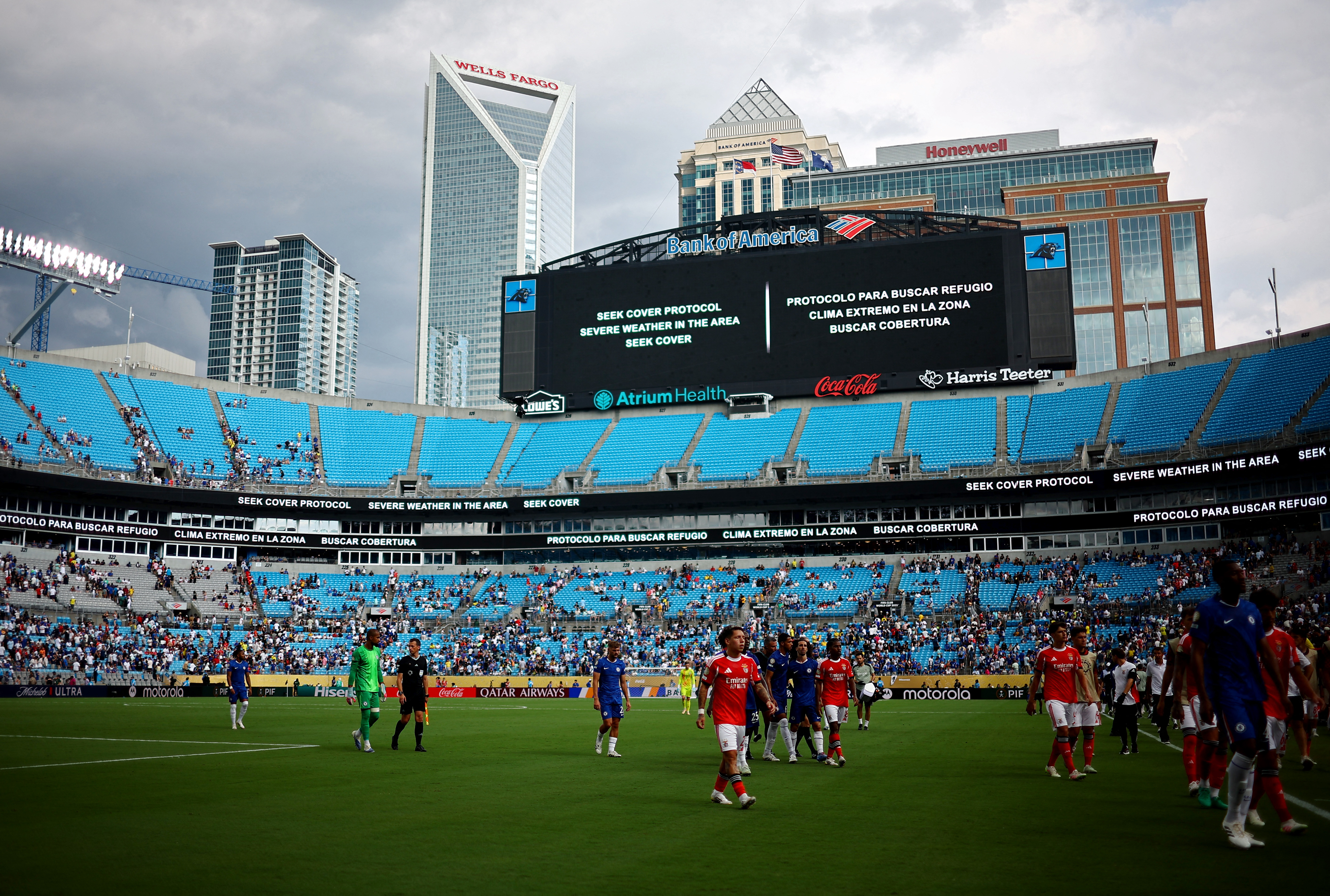 General view of players walking off the pitch after referee Slavko Vincic signals a weather delay to the match