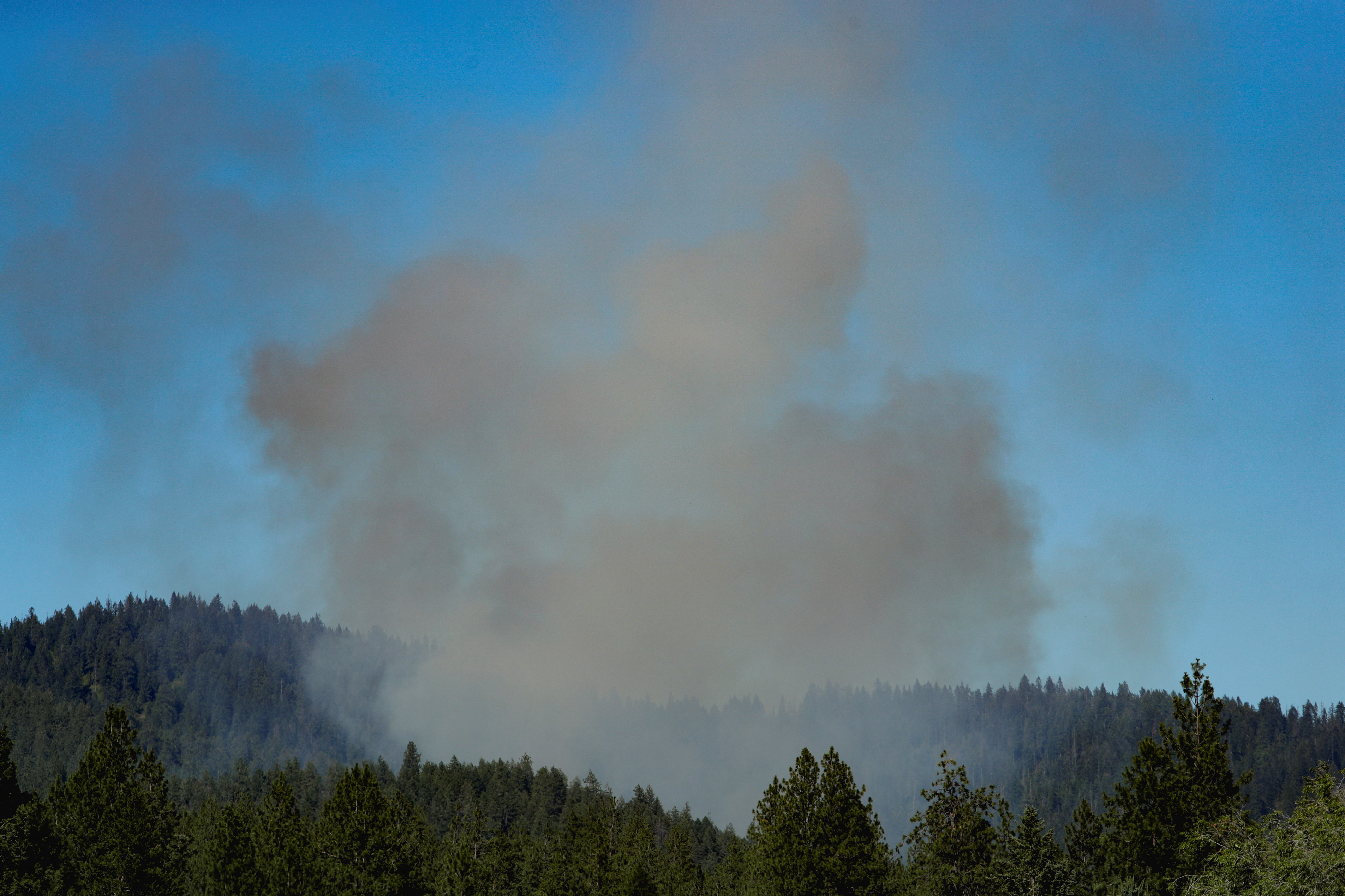 Smoke rises after multiple firefighters were attacked when responding to a fire in the Canfield Mountain