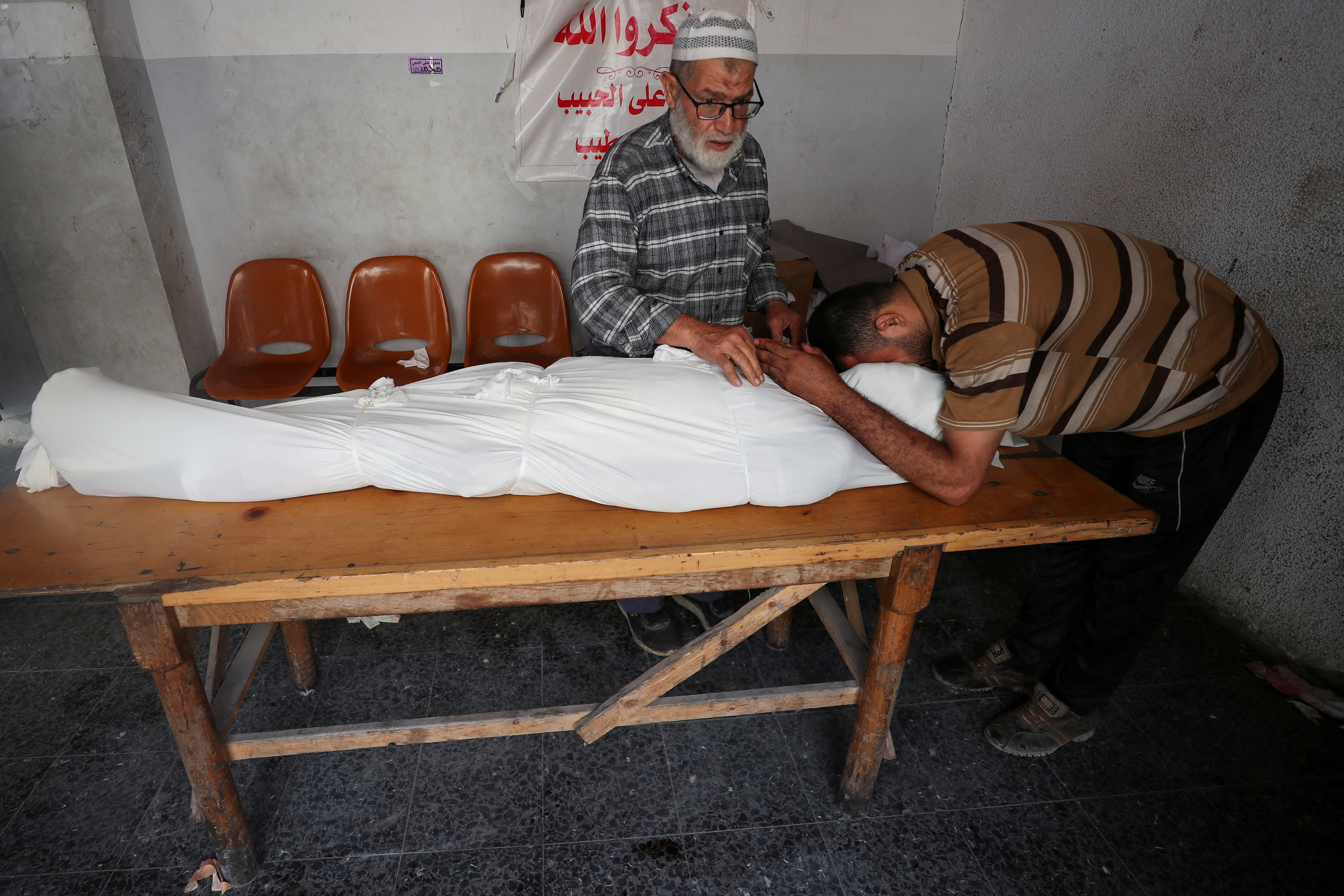 Mourners react during the funeral of Palestinians killed on Sunday in an Israeli air strike on a school, according to Gaza's health ministry, at Al-Ahli Arab Hospital
