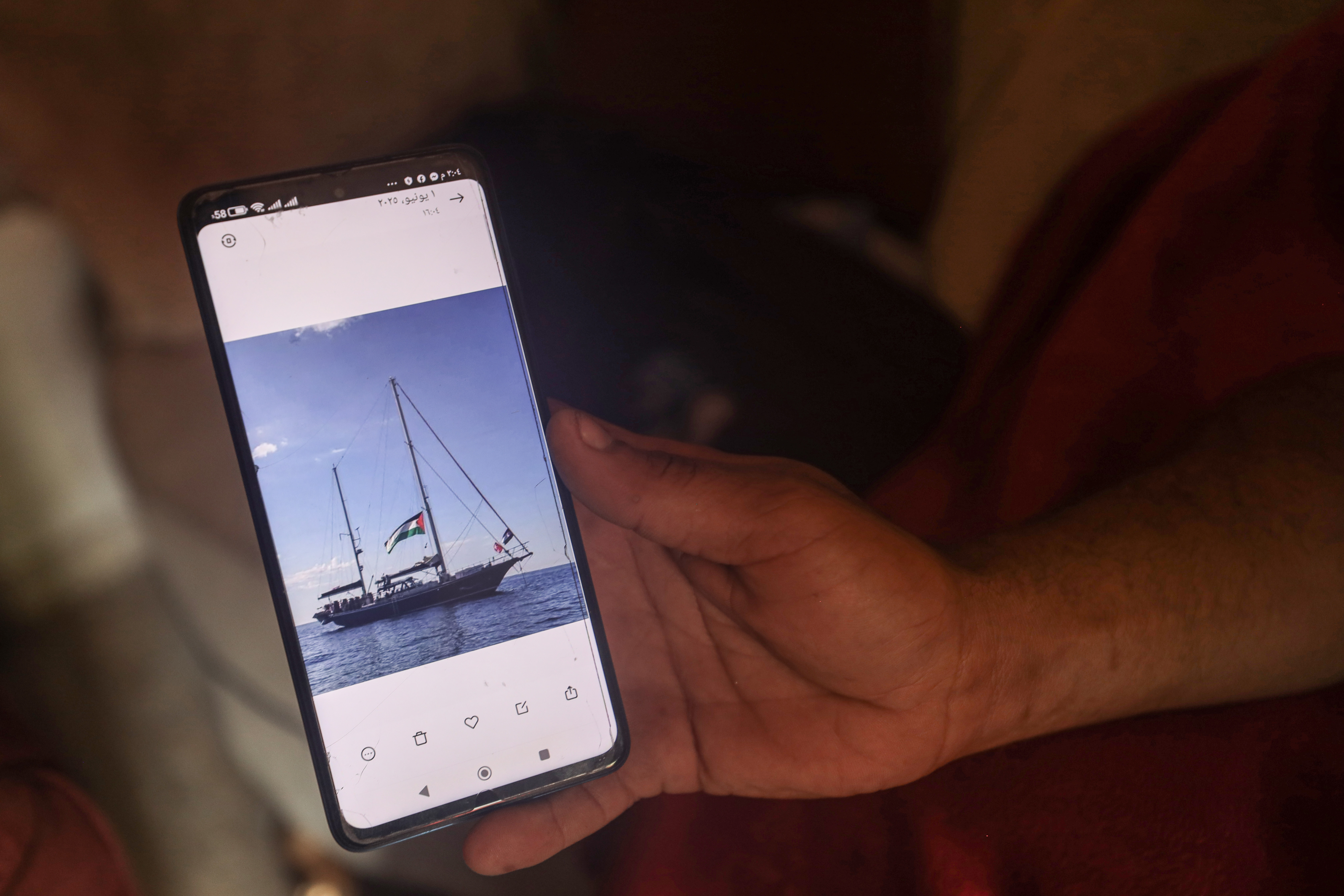 An image of a vessel appears on a phone