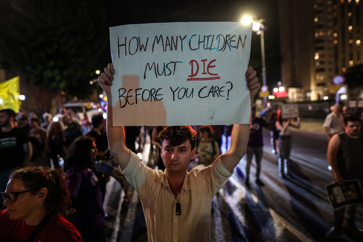 someone holds up a protest sign