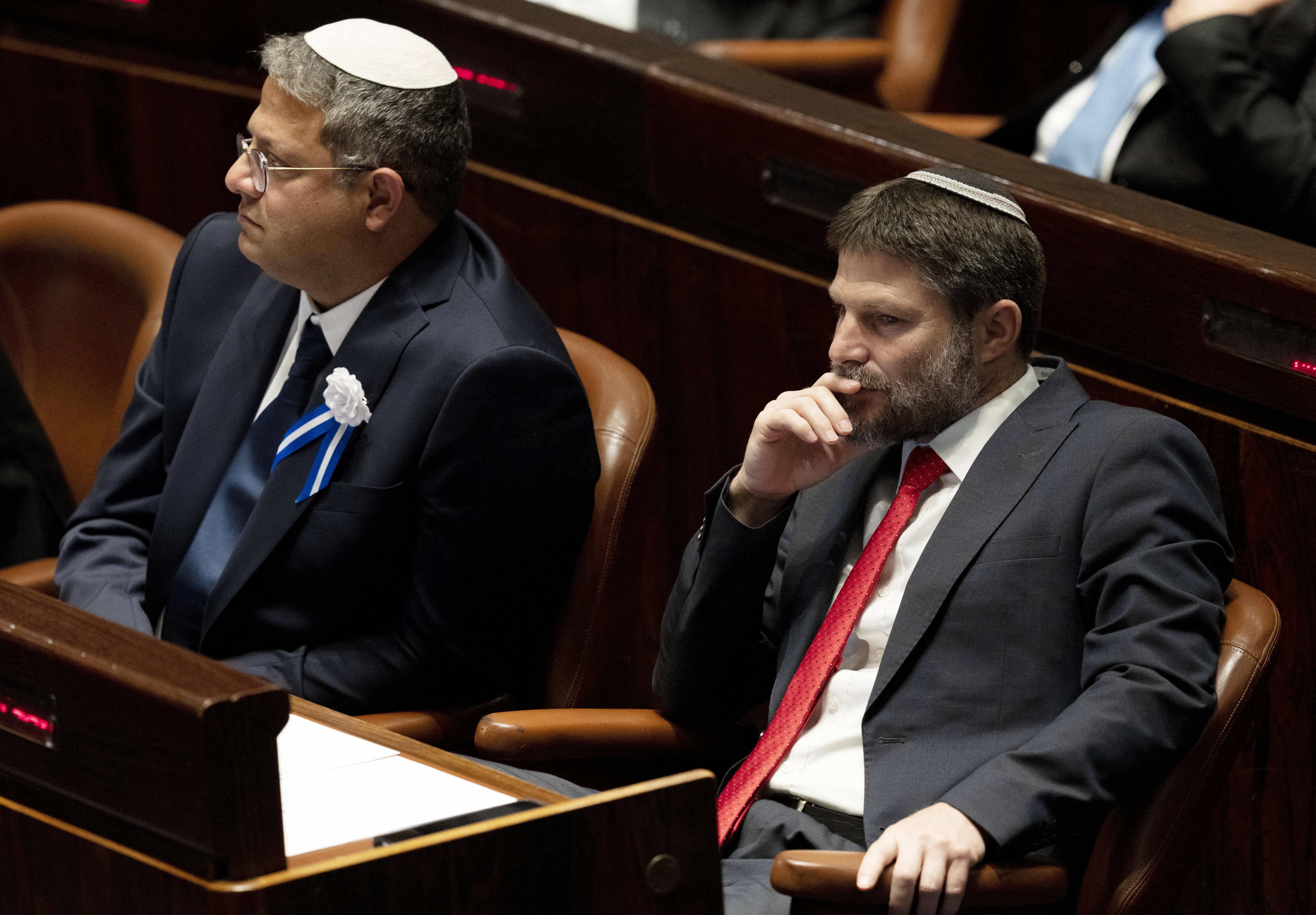 Israeli right wing Knesset member Itamar ben Gvir (L) and Bezalel Smotrich (R) are pictured during the swearing in ceremony of the new Israeli government at the Knesset (Israeli parliament) in Jerusalem, on November 15, 2022. Israel swore in a new parliament today hours after a deadly attack, as veteran hawk Benjamin Netanyahu advances talks on forming what could be the country's most right-wing government ever. (Photo by Maya Alleruzzo / POOL / AFP)