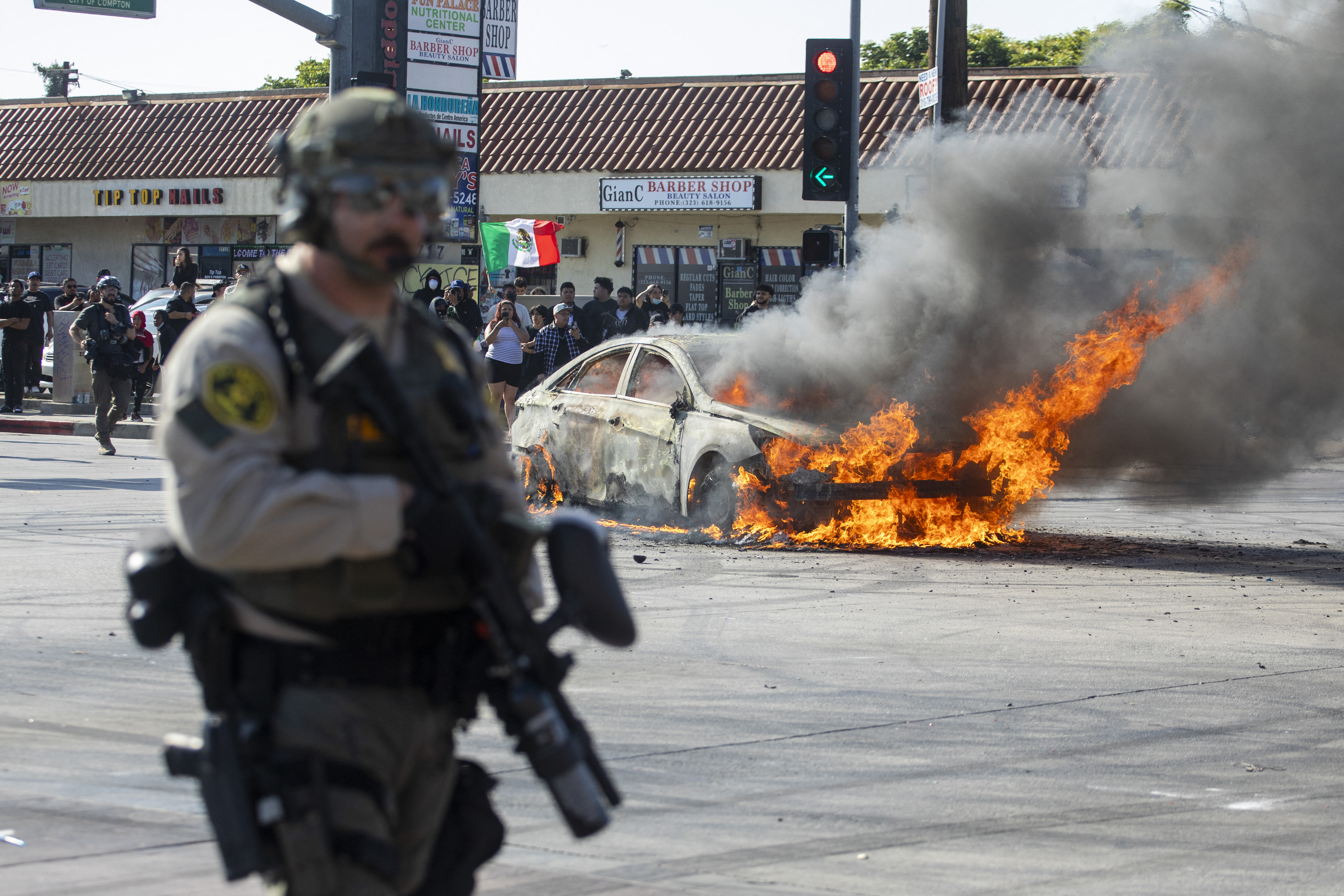 A car burns during a protest following federal immigration operations, in the Compton neighbourhood of Los Angeles, California on June 7, 2025. [File: Ringo Chiu/AFP]