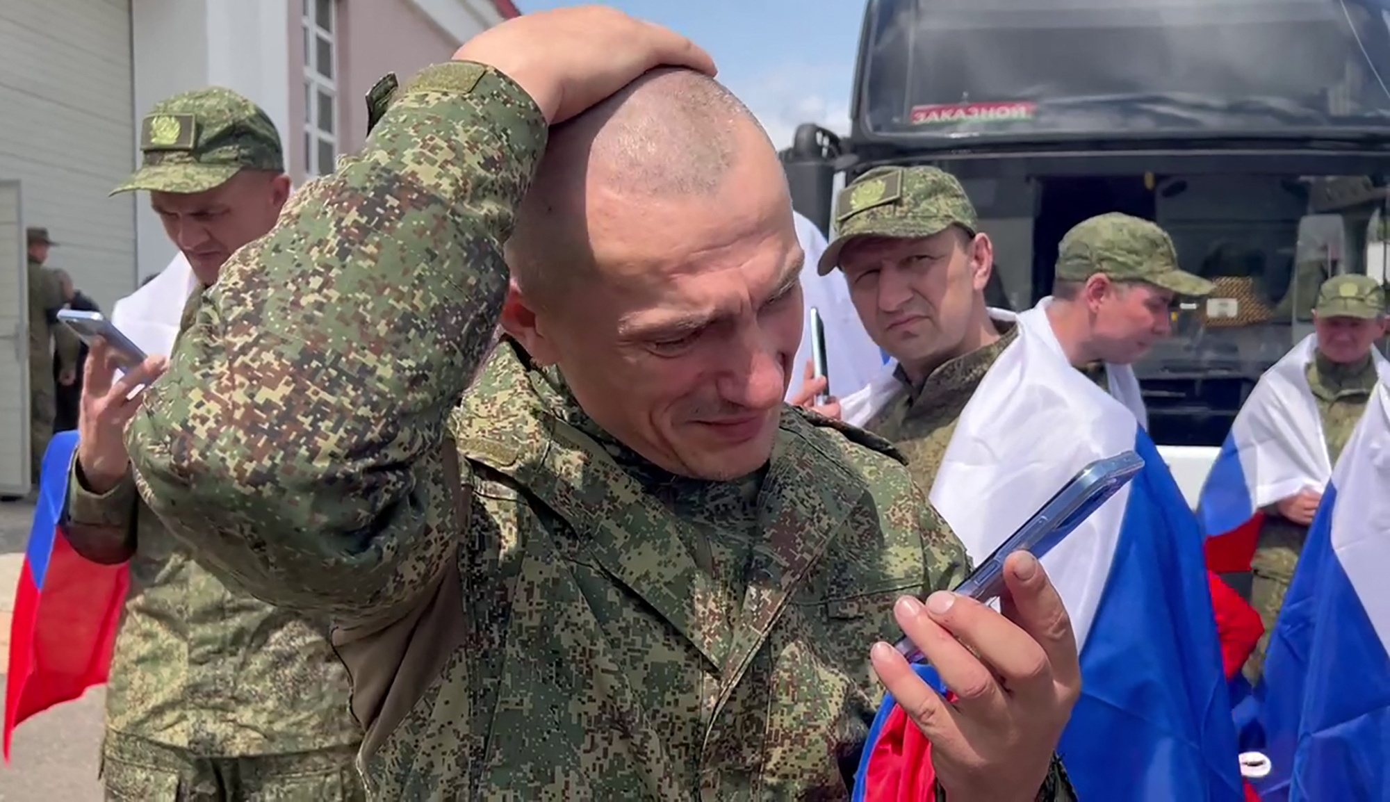 In this video grab taken from a handout footage released by the Russian Defence Ministry on June 12, 2025, Russian prisoners of war (POWs) react following an exchange at an undisclosed location in Belarus. Ukraine and Russia said on June 12, 2025 they had swapped a fresh group of prisoners of war, the third exchange this week as part of a deal agreed at peace talks in Turkey. (Photo by Handout / Russian Defence Ministry / AFP) / RESTRICTED TO EDITORIAL USE - MANDATORY CREDIT "AFP PHOTO / RUSSIAN DEFENCE MINISTRY" - HANDOUT - NO MARKETING NO ADVERTISING CAMPAIGNS - DISTRIBUTED AS A SERVICE TO CLIENTS - AFP CANNOT INDEPENDENTLY VERIFY THE AUTHENTICITY OR LOCATION, DATE, AND CONTENT OF THESE IMAGES. /