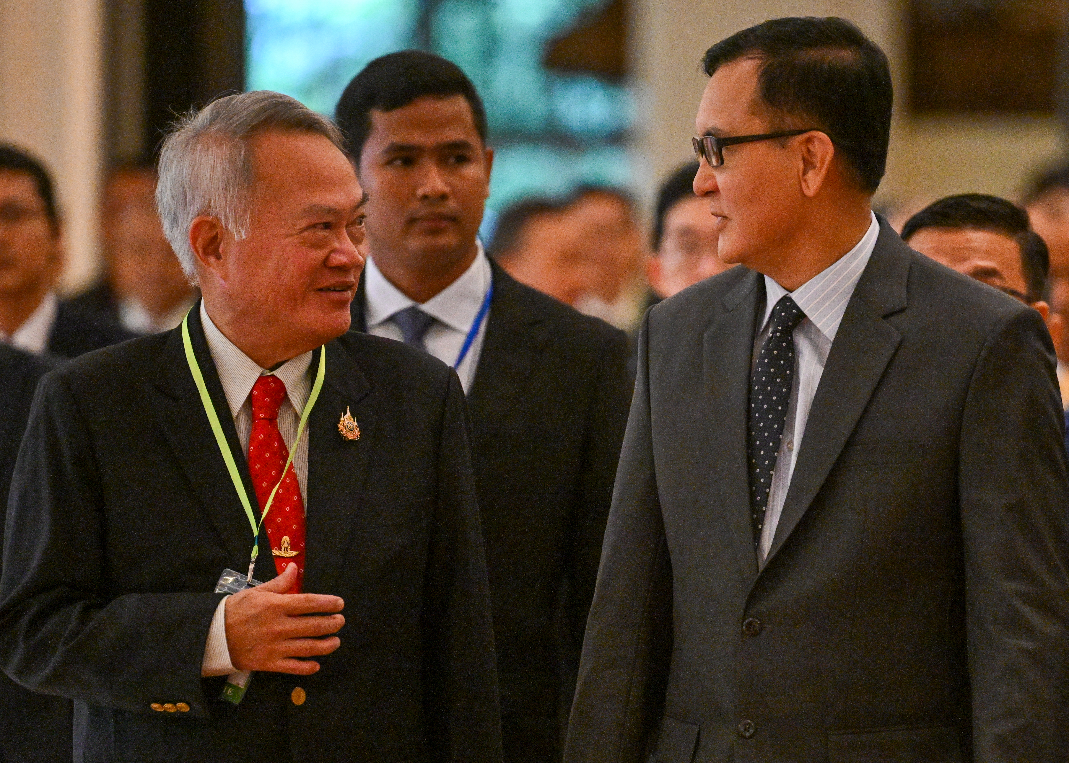 Cambodia's Minister in Charge of the State Secretariat of Border Affairs Lam Chea (R) speaks to Thai Advisor to the Ministry of Foreign Affairs Prasas Prasasvinitchai (L) during the sixth meeting of the Cambodian-Thai Joint Commission on Demarcation for Land Boundary (JBC) in Phnom Penh on June 14, 2025.
