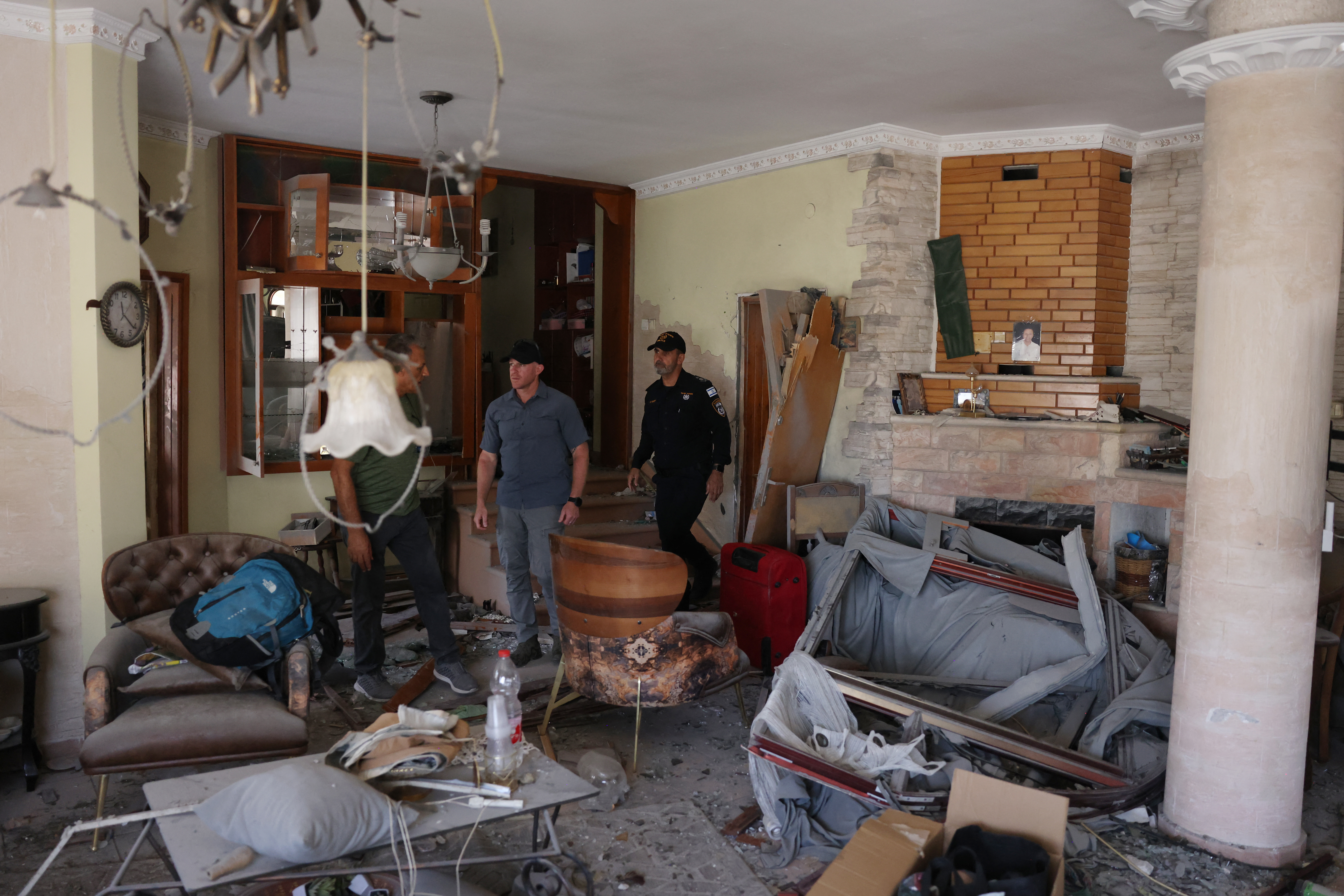 Israeli police inspect on June 17, 2025 a damaged apartment near the site where an Iranian missile destroyed a three-storey building in the northern Arab-Israeli city of Tamra on the weekend, killing four women, according to rescuers and medics. A day after the strike, an Israeli member of parliament of Palestinian descent, accused the government of failing to provide Arab-Israeli communities in Israel with enough shelters. (Photo by AHMAD GHARABLI / AFP)