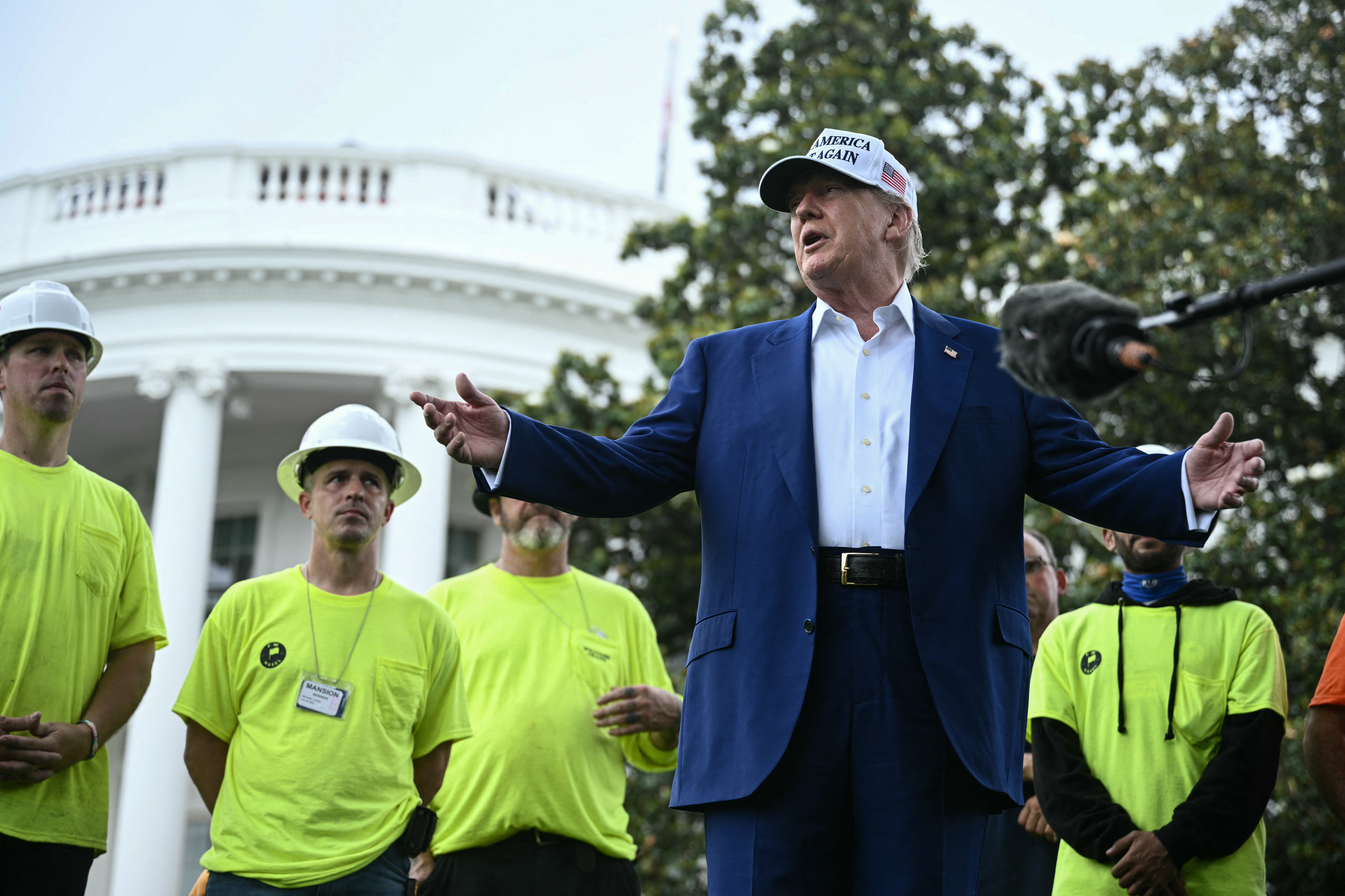 US President Donald Trump speaks to the press as workers install a large flag pole on the South Lawn of the White House in Washington, DC on June 18, 2025. [Brendan SMIALOWSKI / AFP]
