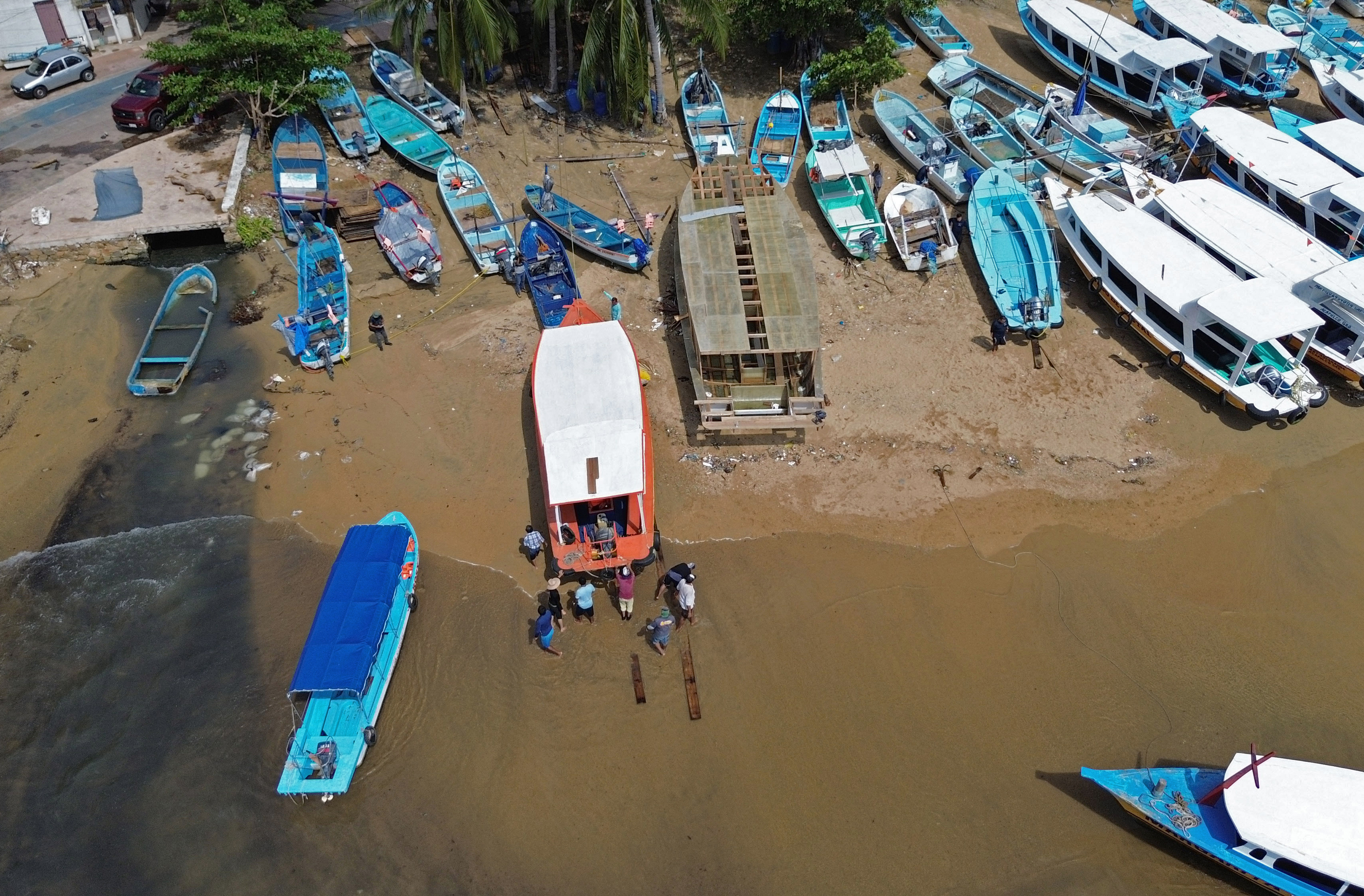 In this aerial view a boat is taken out from the sea as preparations are made for the arrival of Hurricane Erick