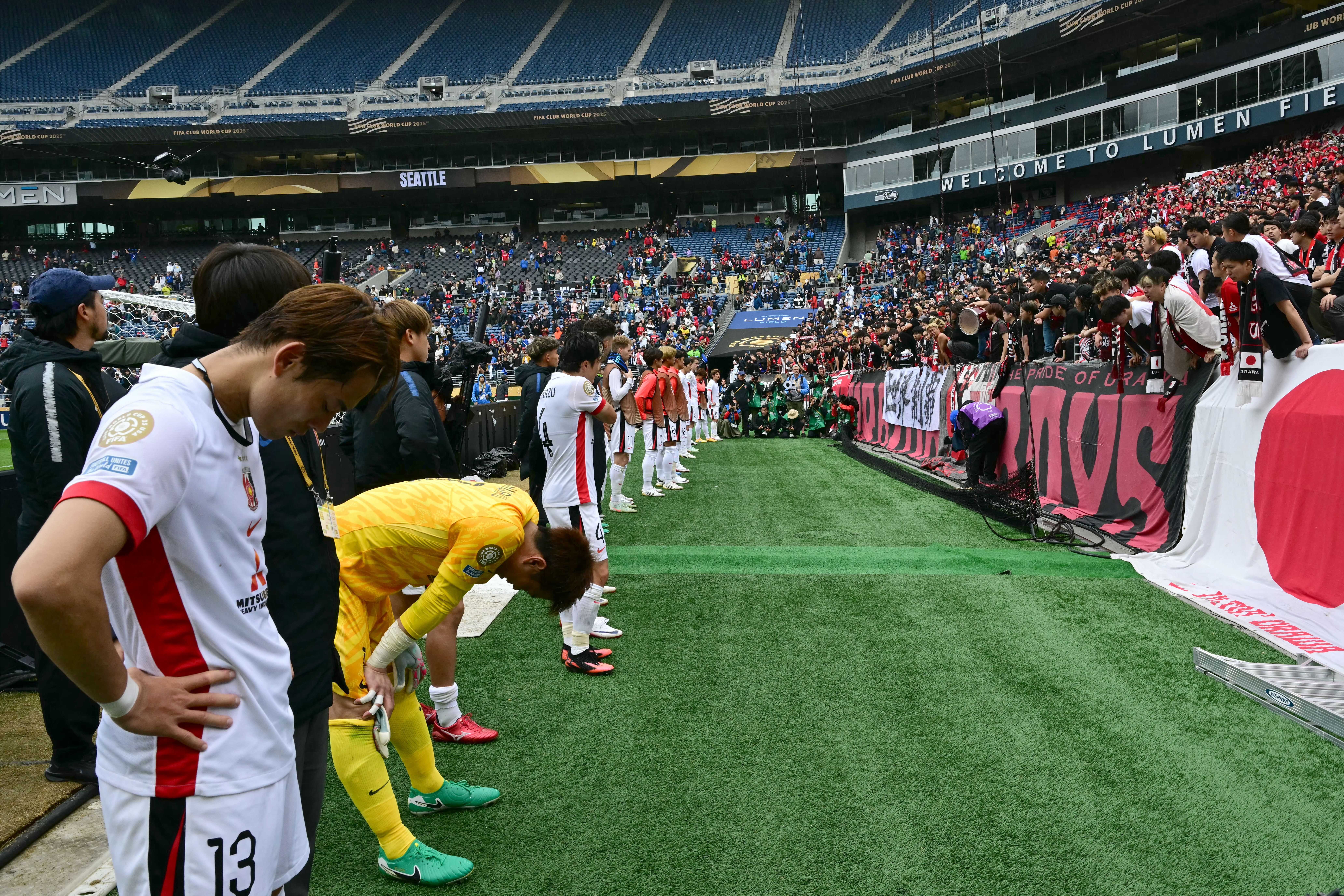 Urawa Red Diamonds players acknowledge their supporters at the end of the FIFA Club World Cup 2025 Group E football match between Italy's Inter Milan and Japan's Urawa Red Diamonds at the Lumen Field stadium in Seattle on June 21, 2025. (Photo by Pablo PORCIUNCULA / AFP)