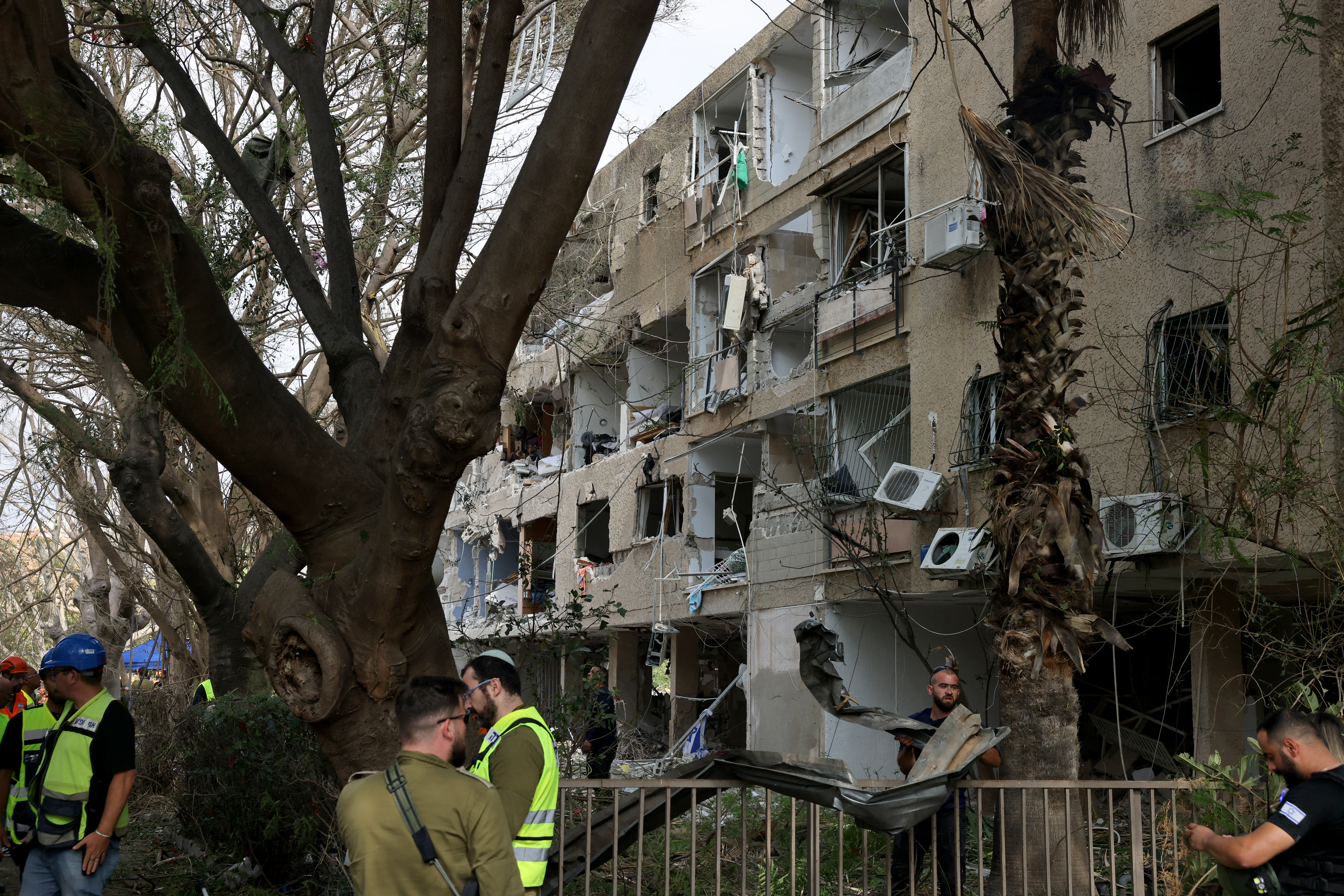 Israeli security forces and first responders gather at the site of an Iranian strike