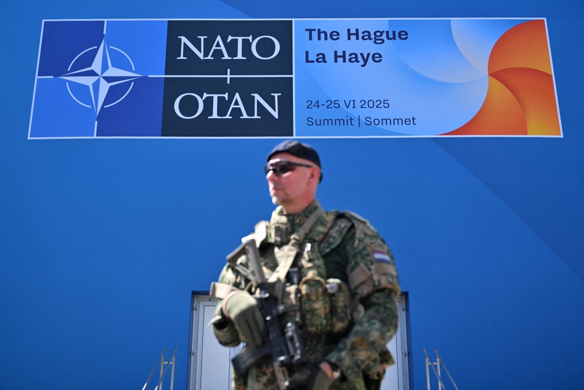 A Dutch soldier stands guard at the World Forum venue ahead of a North Atlantic Treaty Organisation (NATO) summit in The Hague, on June 23, 2025. Ukraine's President is scheduled to participate in person at the June 24-25 NATO summit in The Hague, where NATO members are expected to agree a major increase in defence spending under pressure from US President at the gathering. [Nicolas Tucat/AFP]