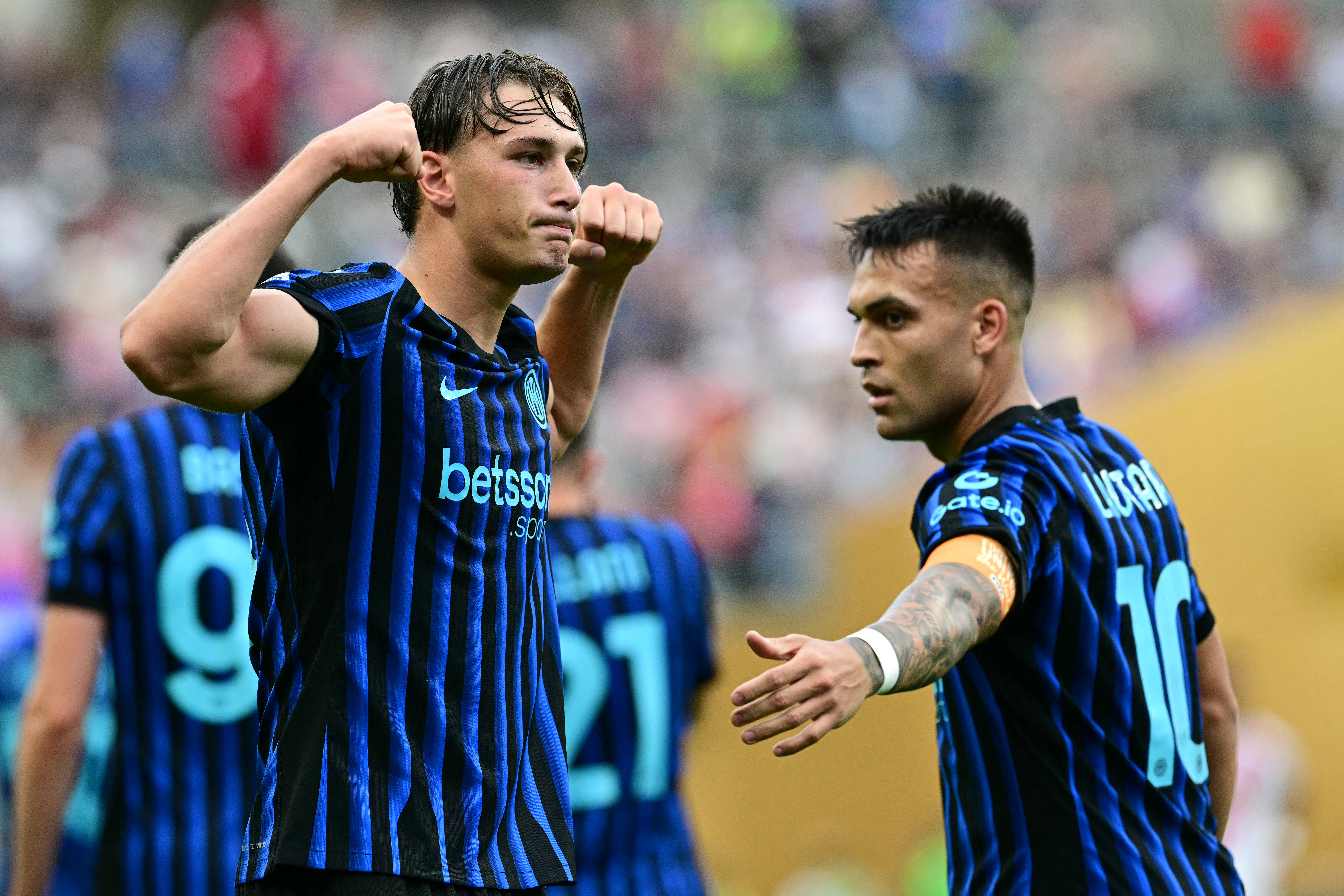 Inter Milan's Italian forward #94 Francesco Esposito (L) celebrates next to teammate Argentine forward #10 Lautaro Martinez after scoring a goal.