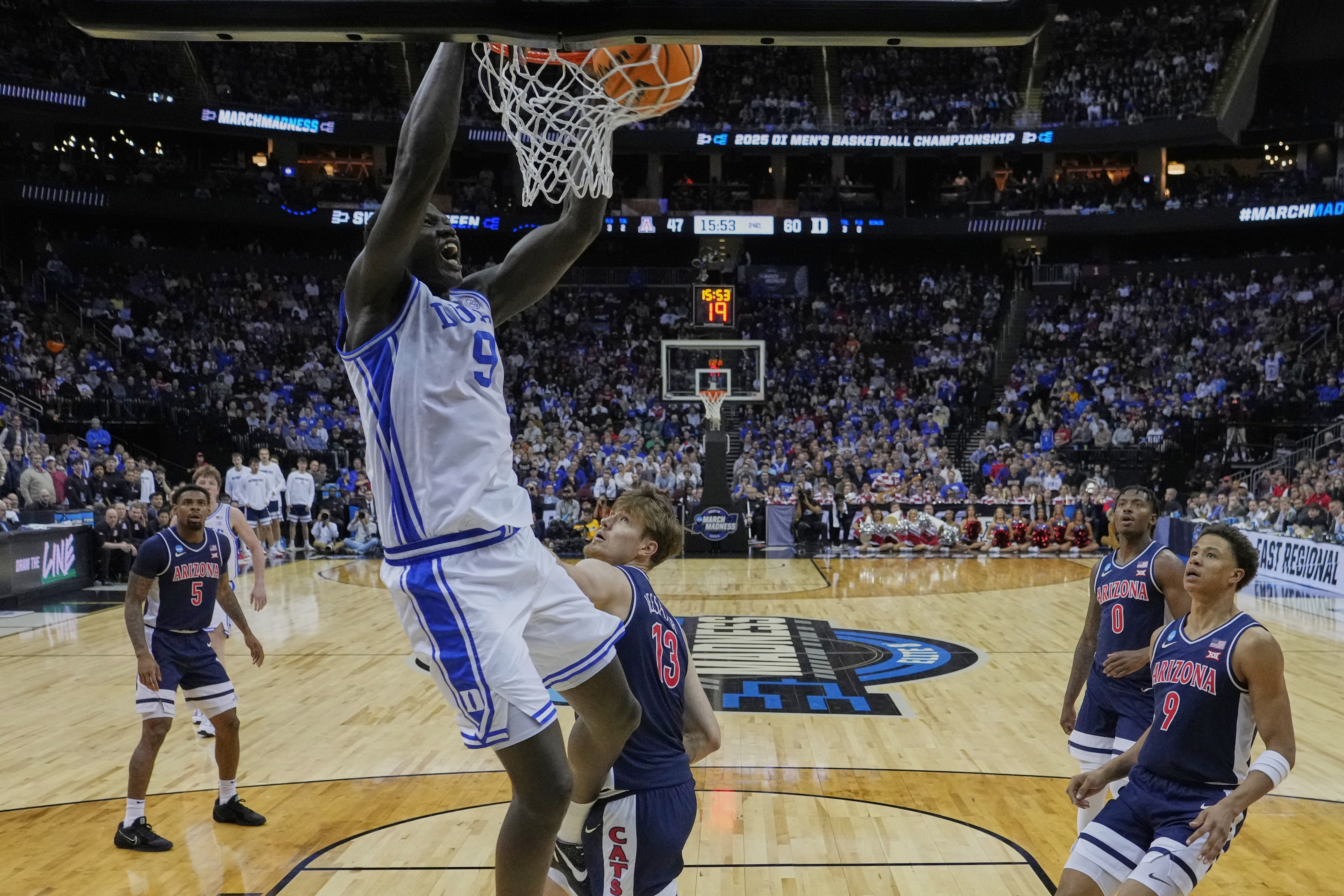 Duke 's Khaman Maluach (9) dunks the ball in front of Arizona's Henri Veesaar (13) and Carter Bryant (9) during the second half of a Sweet 16 round NCAA college basketball tournament game Thursday, March 27, 2025, in New York. (AP Photo/Frank Franklin II)